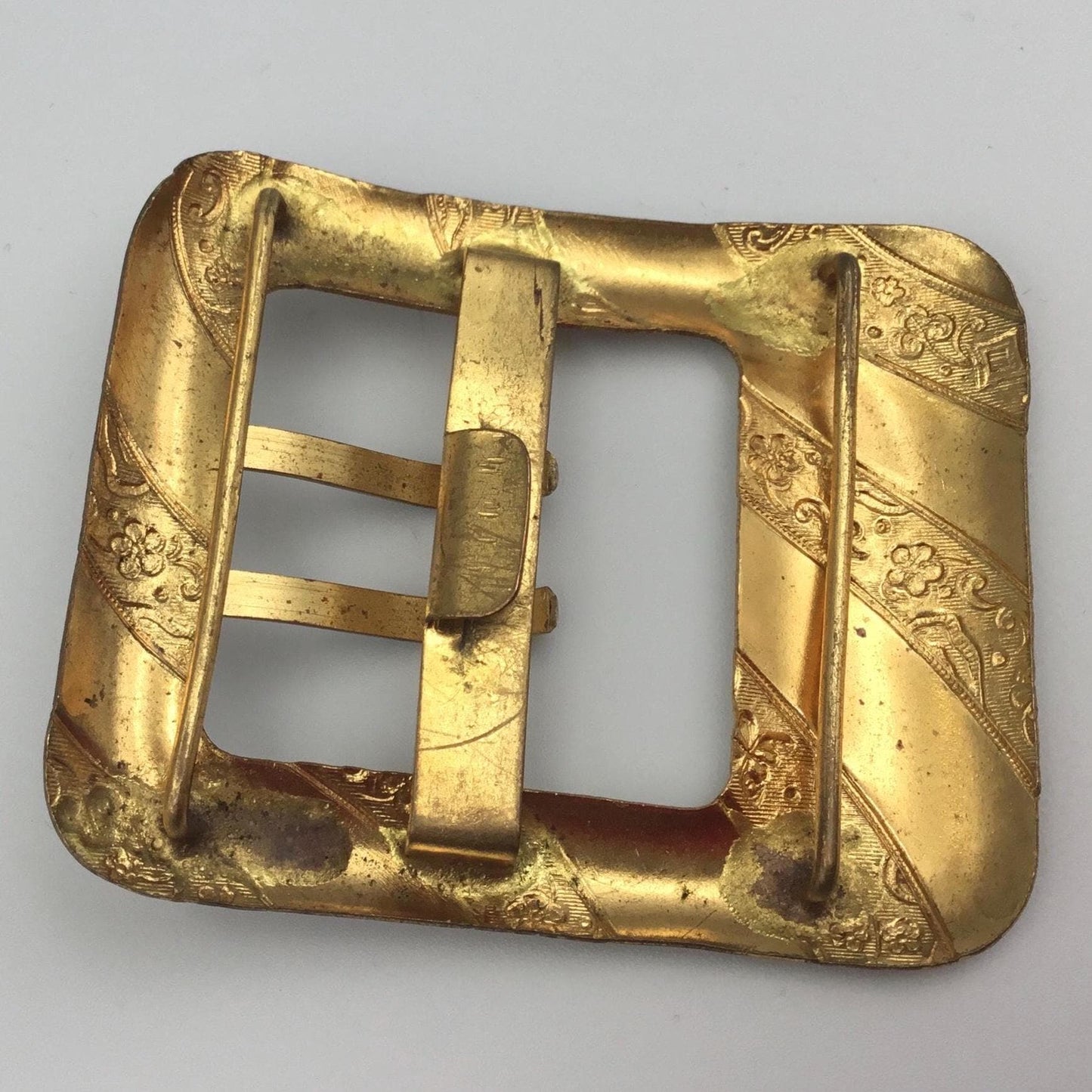 Antique Edwardian gilt metal buckle With floral & butterfly detail in between plain diagonal bands - Splendid Vintage World