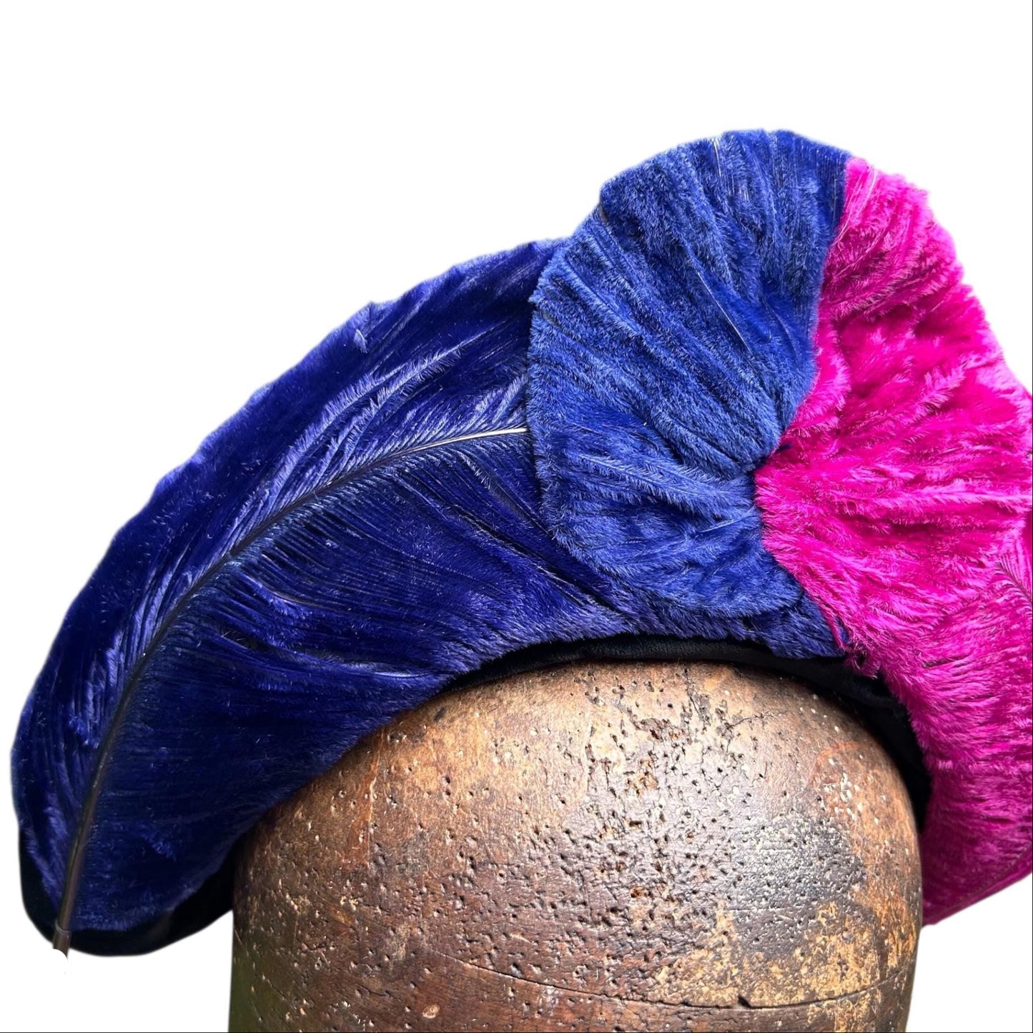 vibrant blue and pink ostrich feather hat brim on brown wooden hat block on white background Vintage World