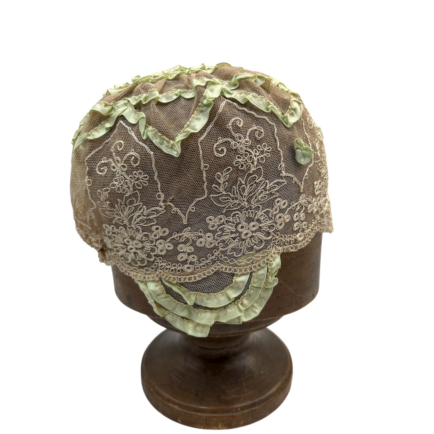cream lace hat with pale green ribbon trim on wooden hat block stand with white background - Splendid Vintage World