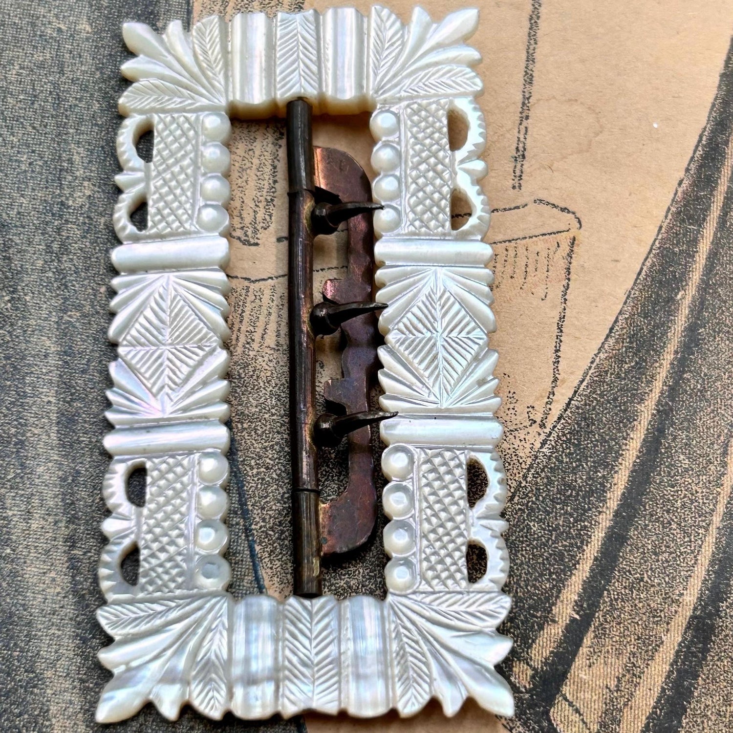 carved crowns mother of pearl Buckle with gold plated fittings on printed victorian fashion magazine - Splendid Vintage World