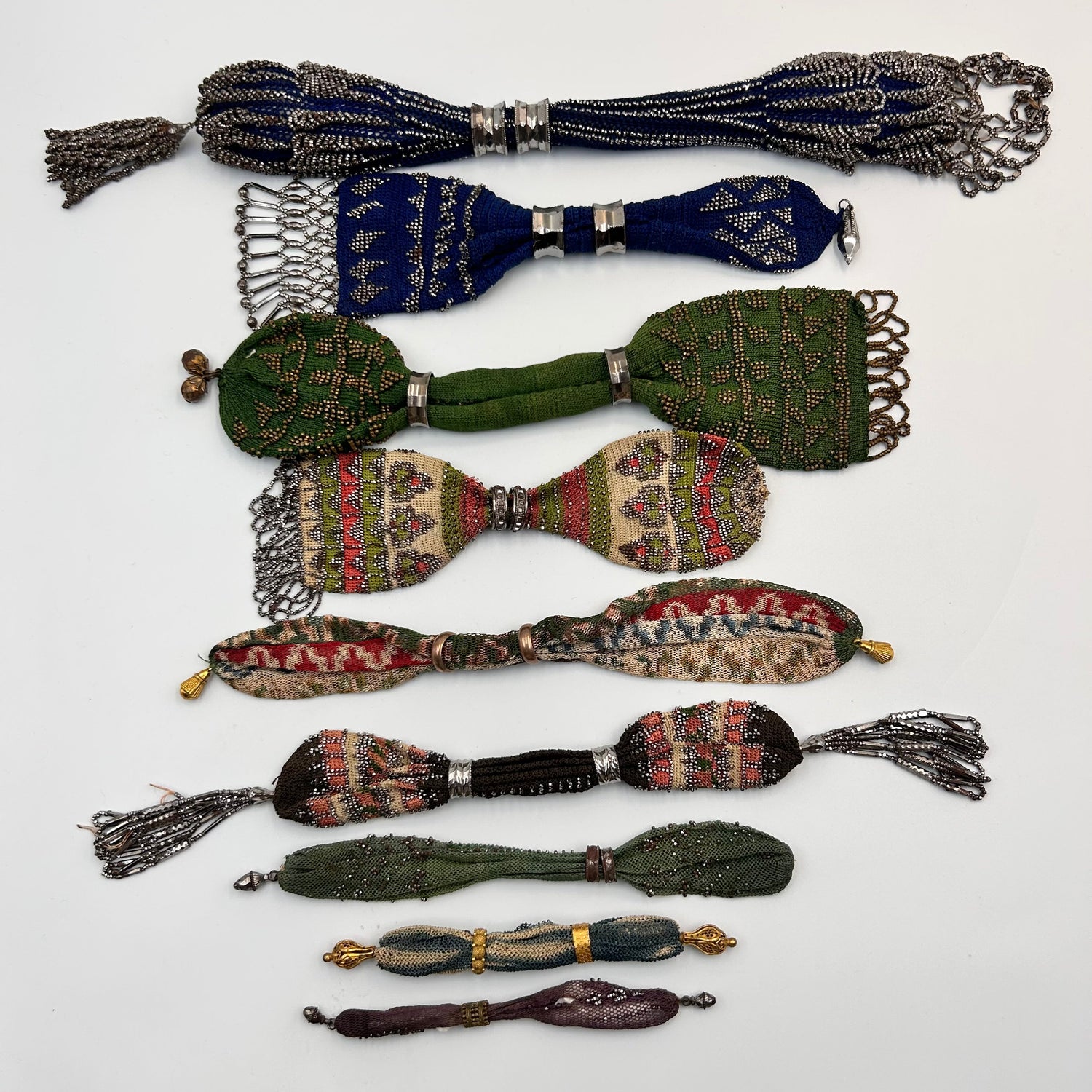 9 cut steel beaded & coloured knitted victorian miser purses displayed on a light background - Splendid Vintage World