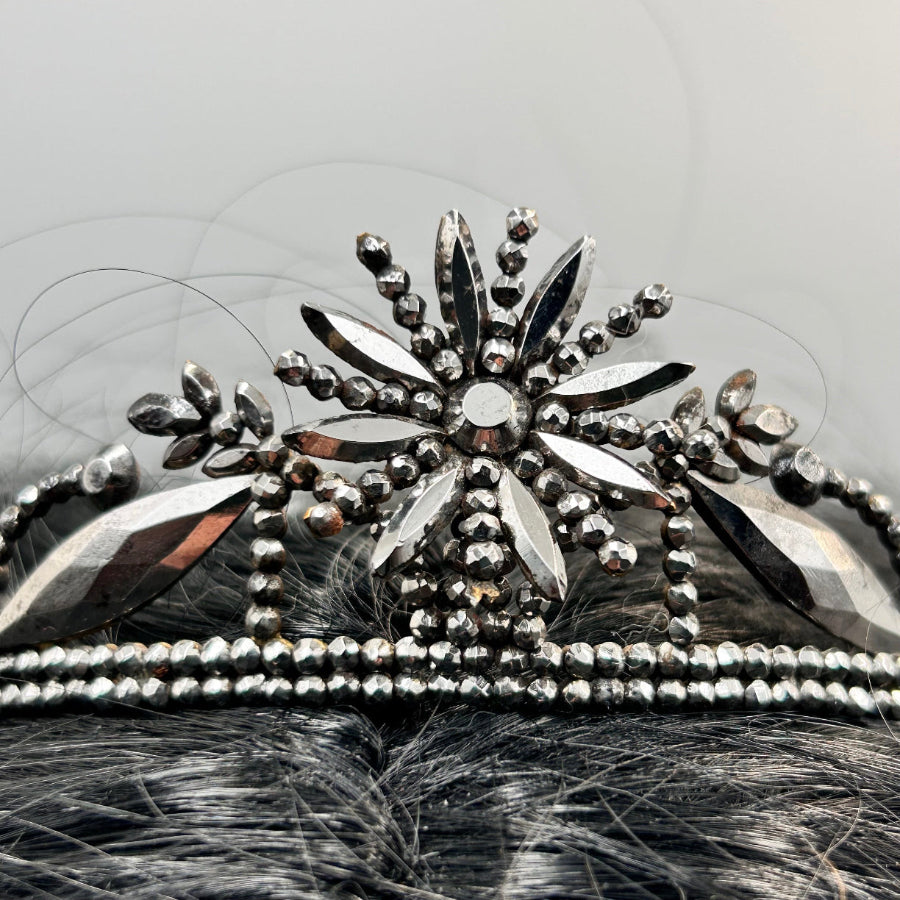 Georgian cut steel tiara on black hair with light background