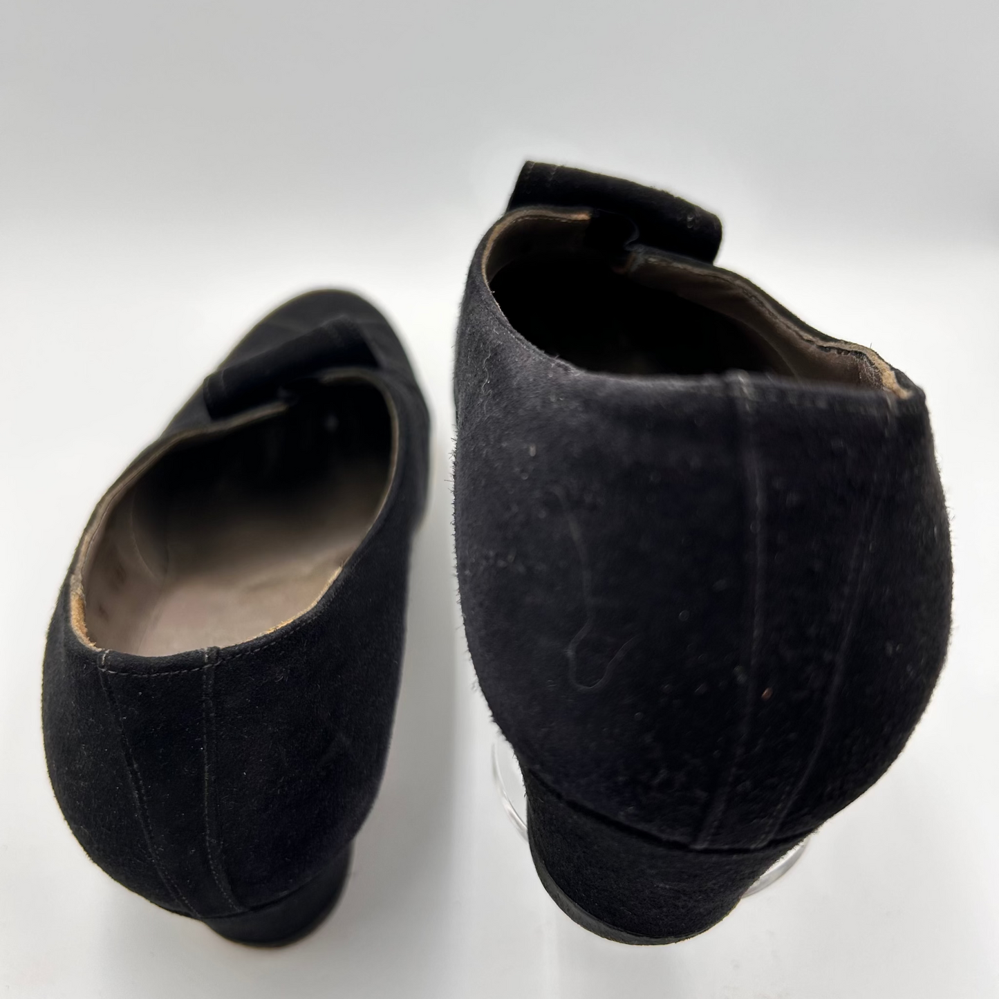 Pair of black suede shoes on a white background