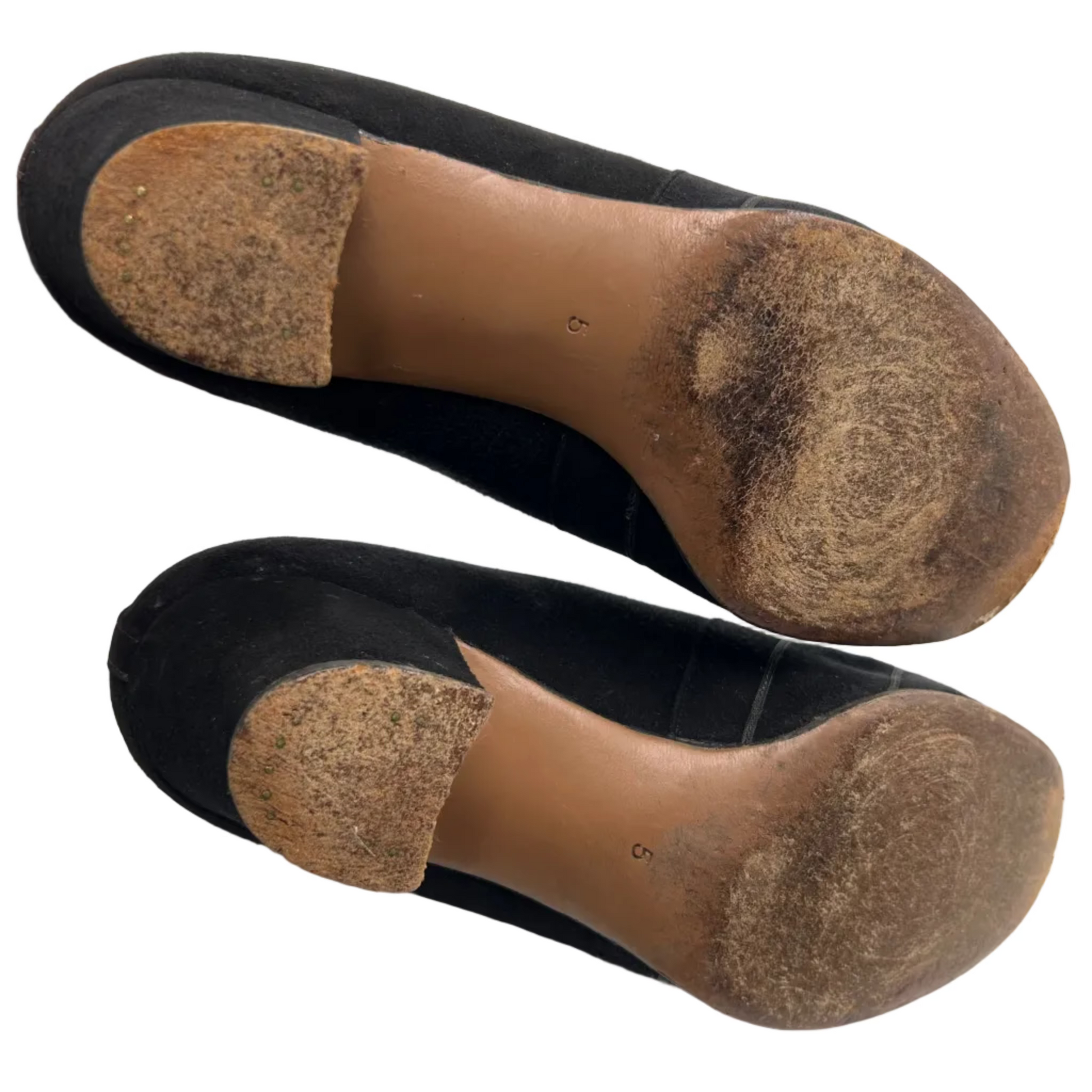 Two worn brown soles of shoes on a white background