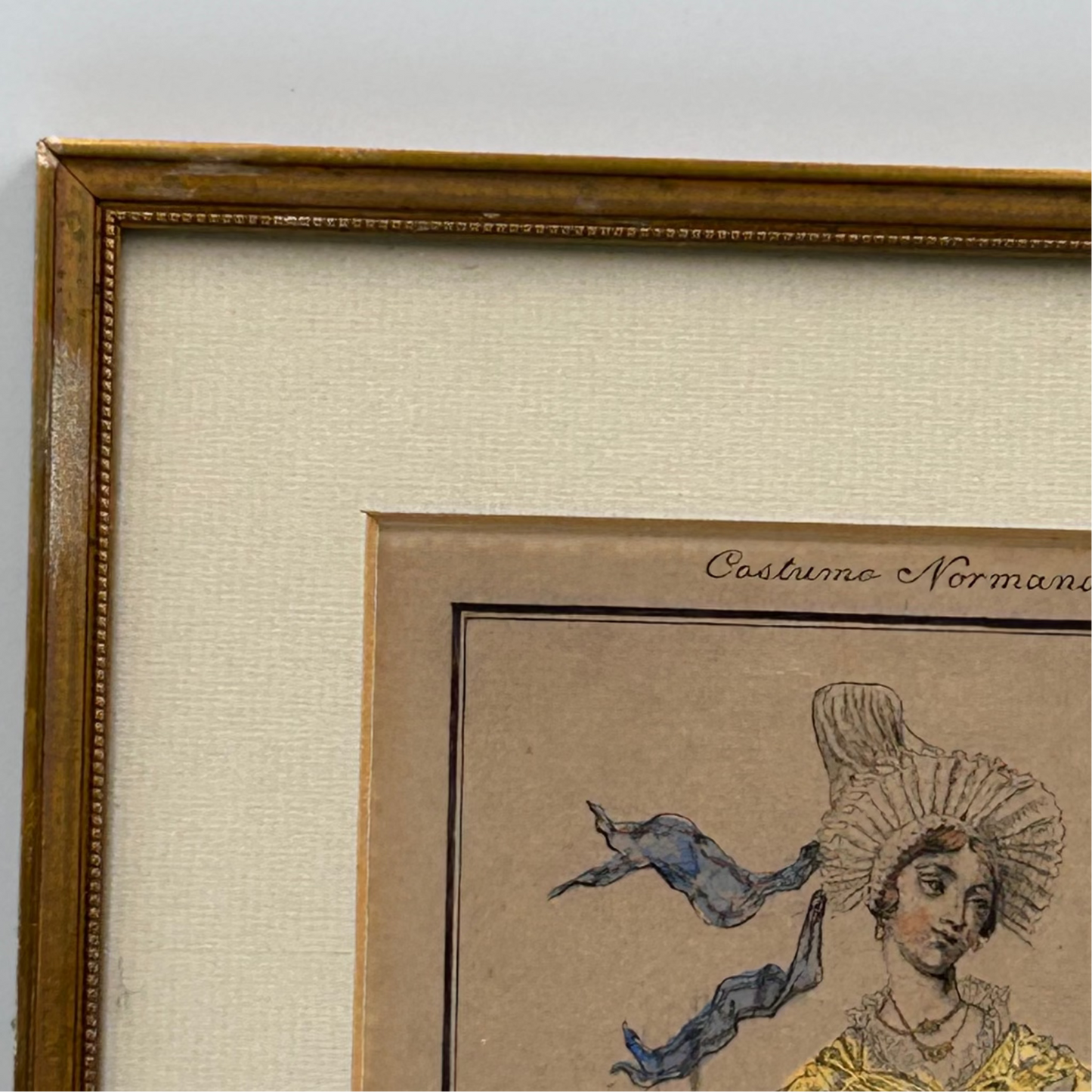 Framed print with detailed illustration of lady wearing a headdress on a beige background, slight damage to corner of frame.