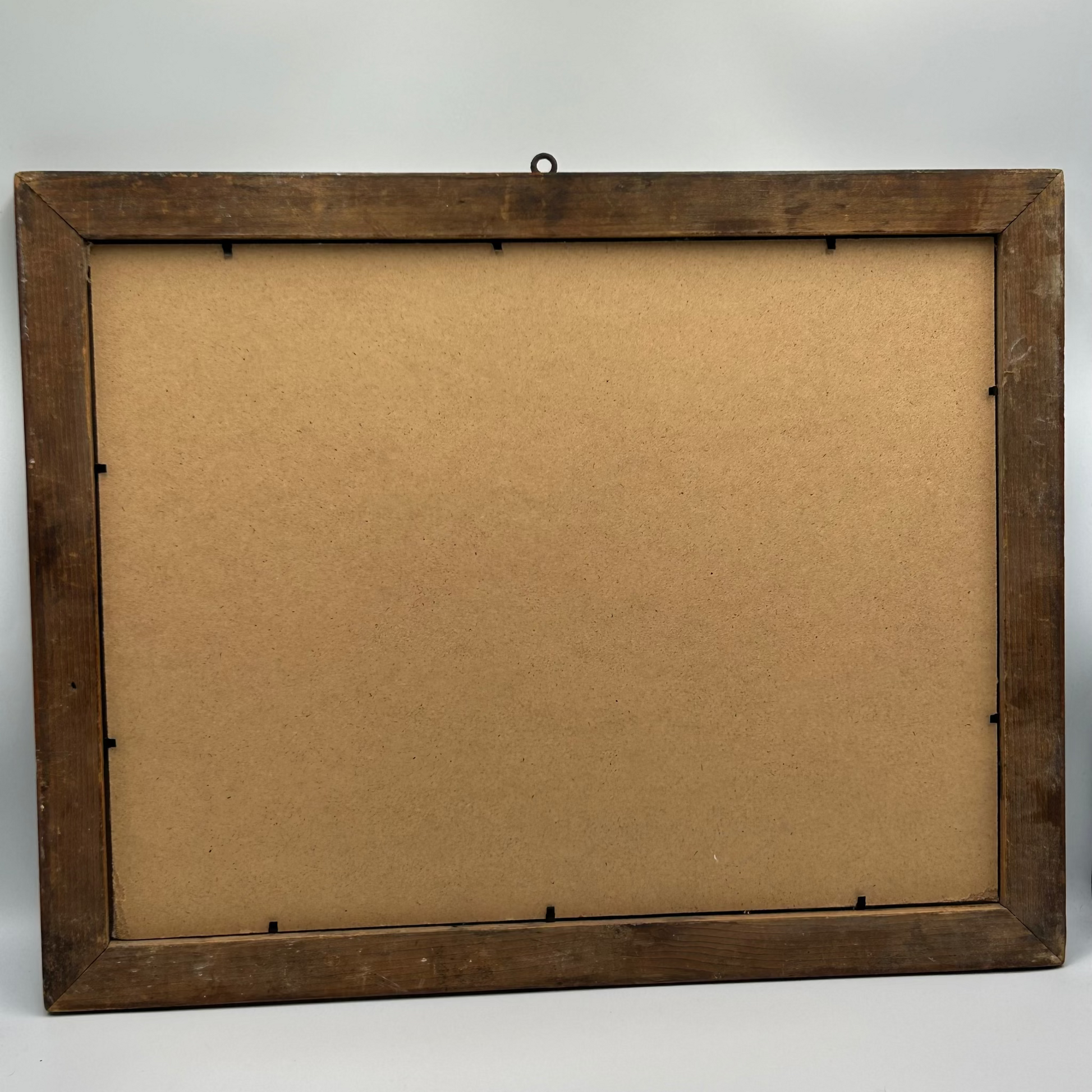 Wooden picture frame with a brown centre on a light grey background