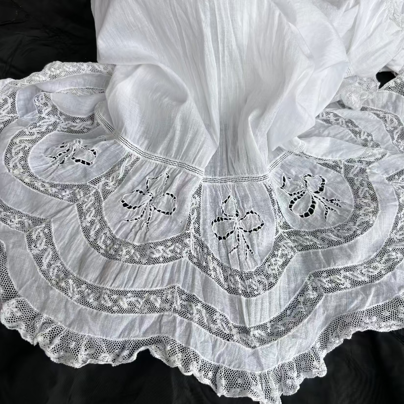 White lace trimmed underwear on black background