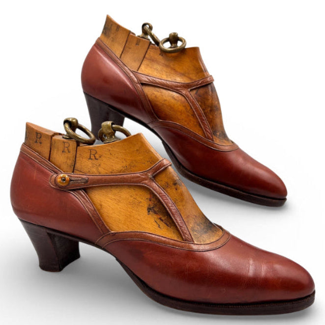 brown 1920s leather shoes with original wood trees on white background