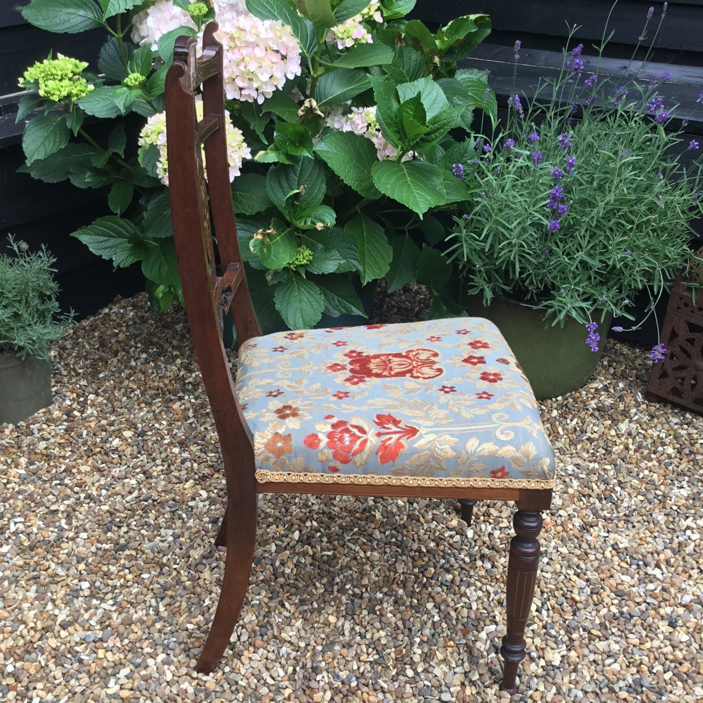 Side view of Edwardian rosewood bedroom chairs which have been newly upholstered in Jim Dickens fabric