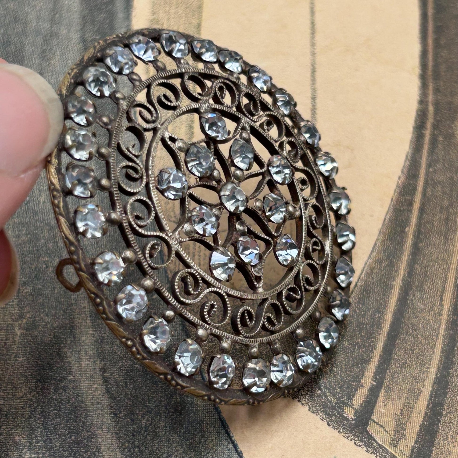 Antique 1900s diamanté hair decoration or dress adornment. Circular in shape it is complete with all stones