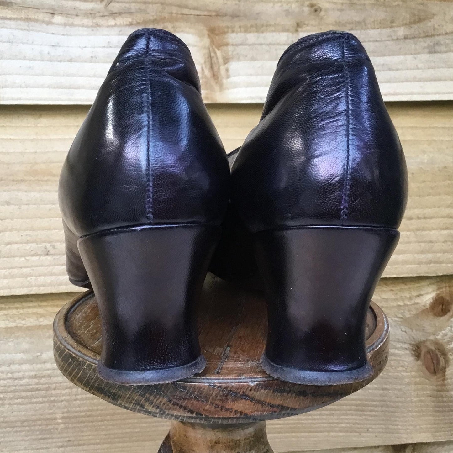 Antique Leather heeled Shoes on a wooden stand with fence background - Splendid Vintage World