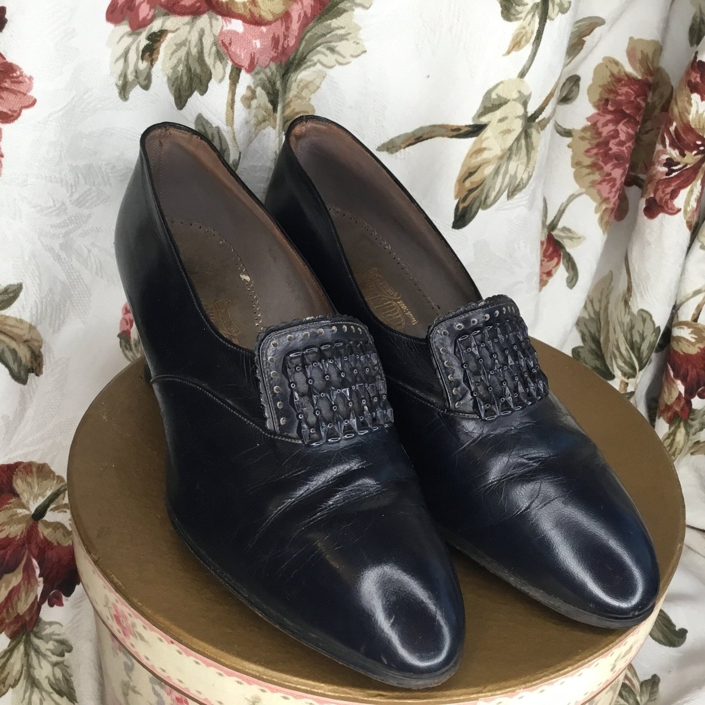 Dark Blue Leather Shoes Buckle adornment on floral box against floral curtain - Splendid Vintage World
