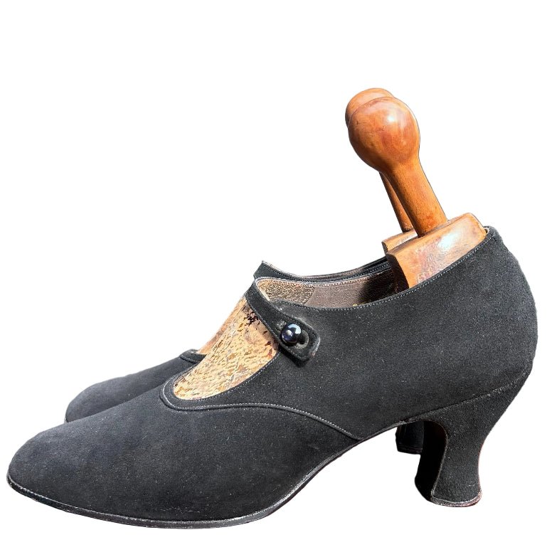 Antique 1920’s black suede shoes with wooden trees against white background - Splendid Vintage World