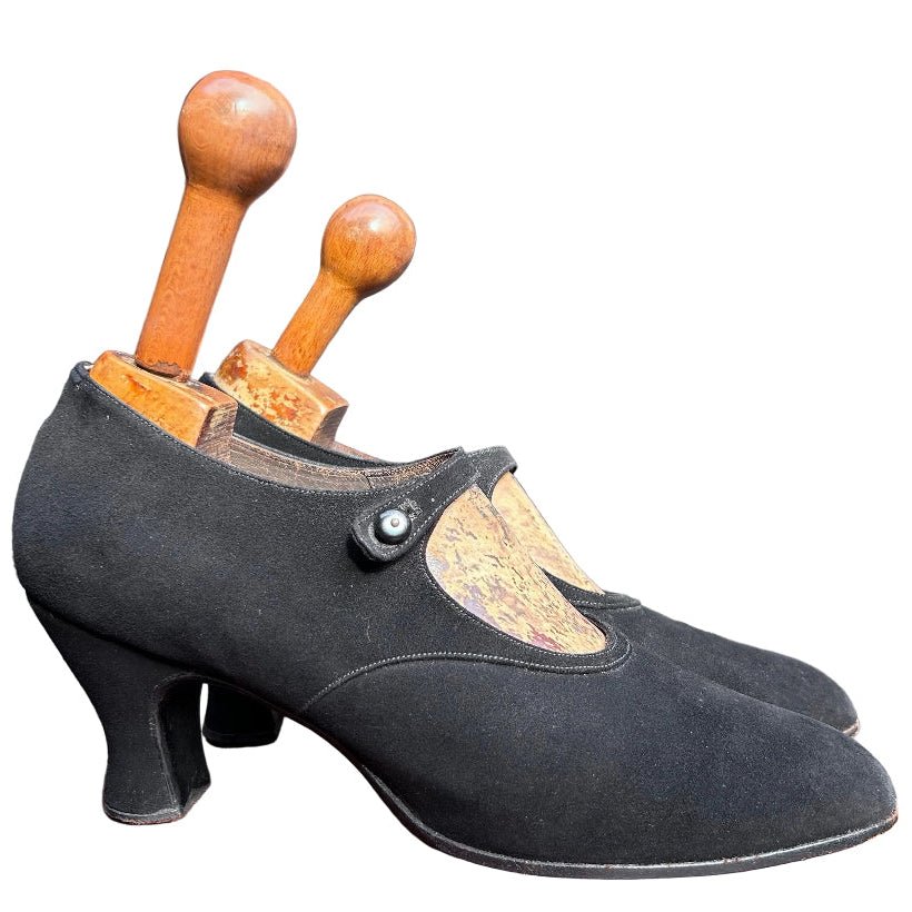 Antique 1920’s black suede shoes against white background - Splendid Vintage World