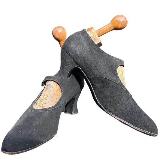 Antique 1920’s black suede shoes with wooden trees against a white background - Splendid Vintage World