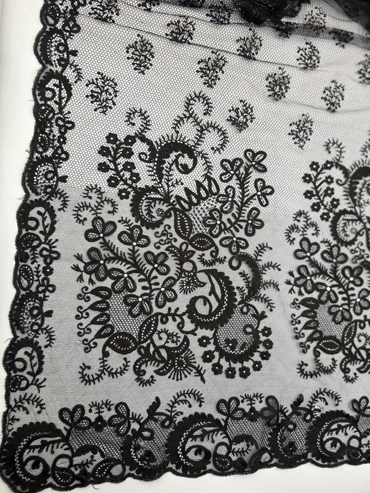 Antique black lace bonnet veil, apron, lace panel with drawstring floral detail close up against white background