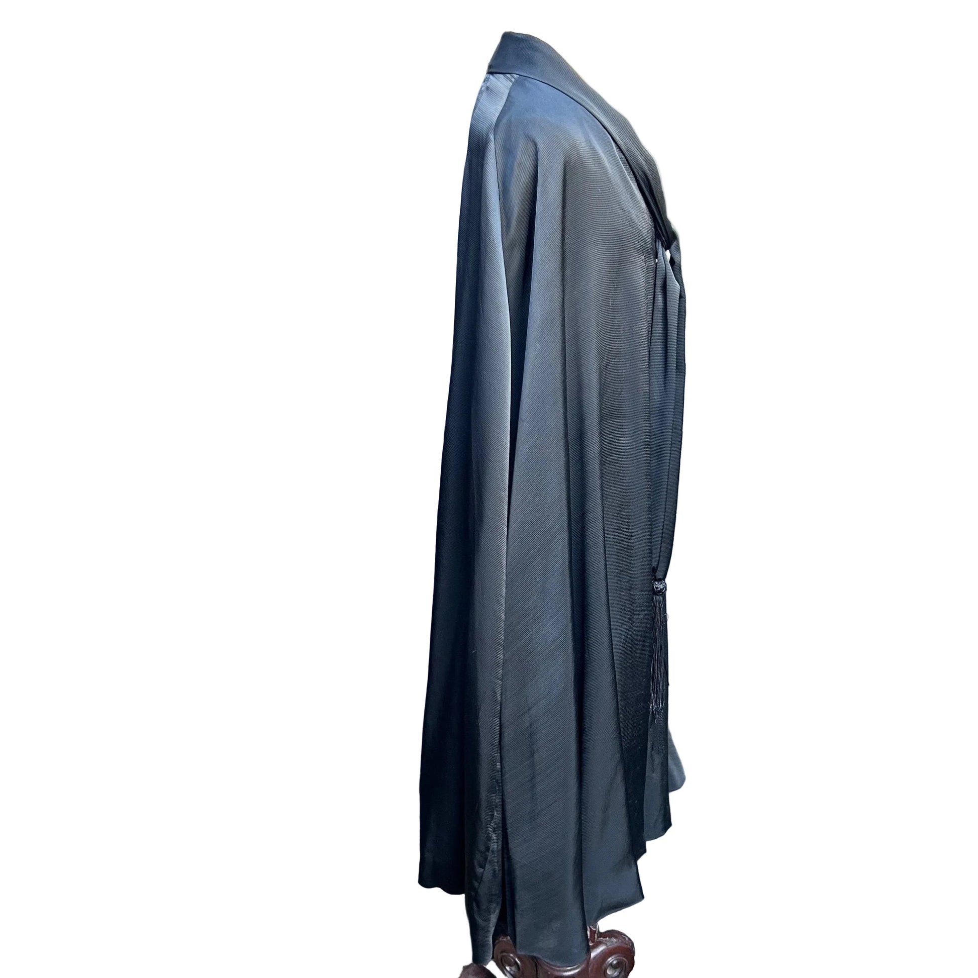 side view of Antique black silk opera cape against white backdrop - Splendid Vintage World