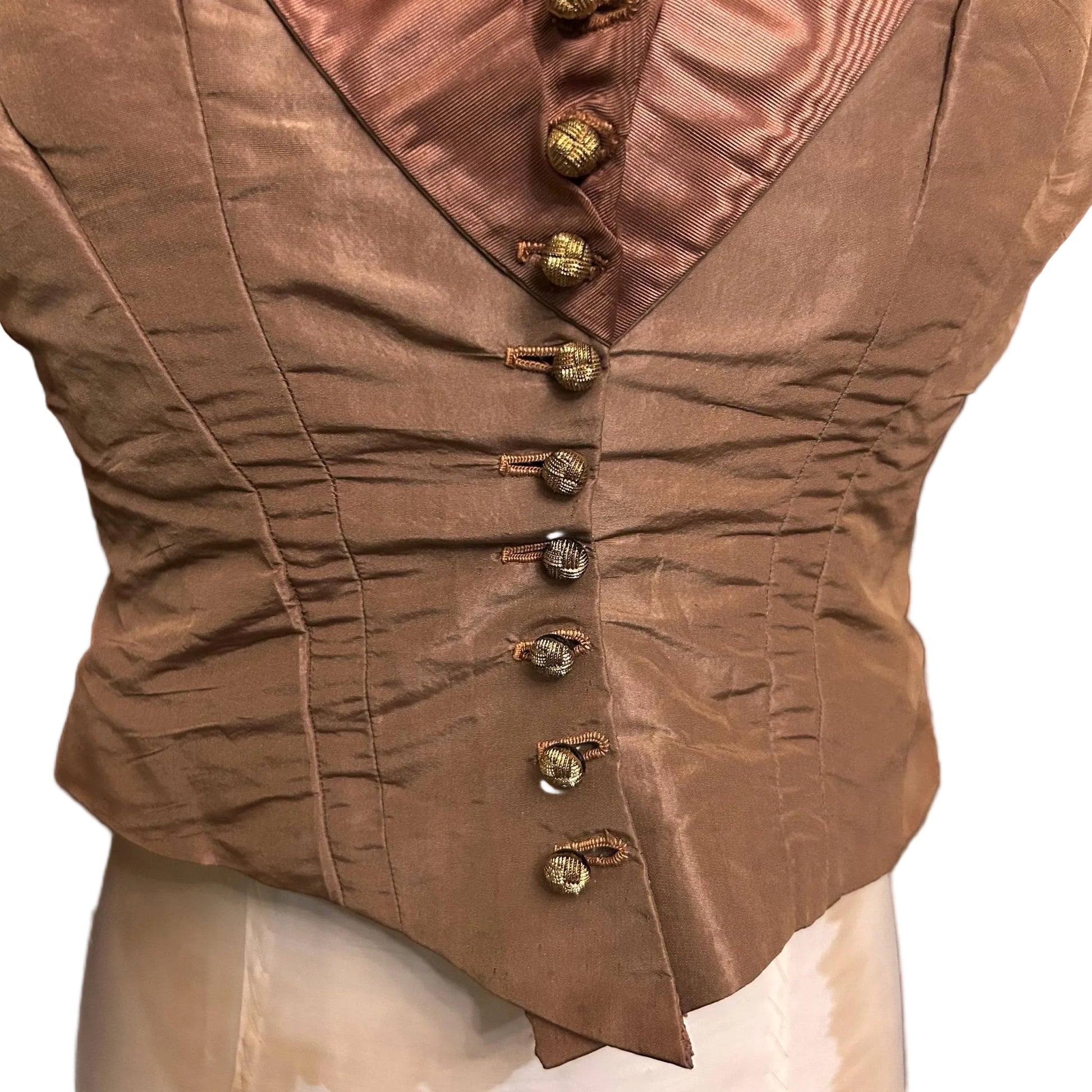 Antique bodice in brown copper glass buttons close up on mannequin against white background - Splendid Vintage World
