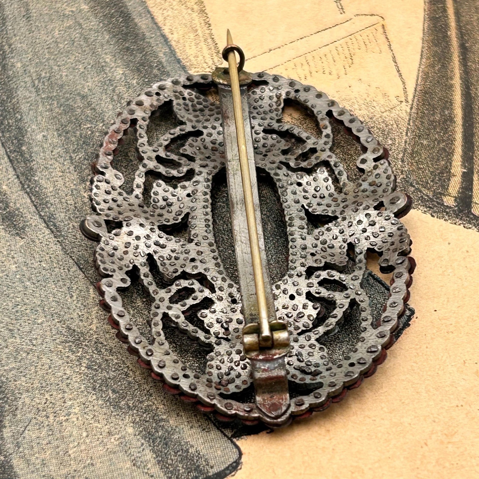 Antique butterfly brooch cut steel pinned construction back view on printed magazine - Splendid Vintage World