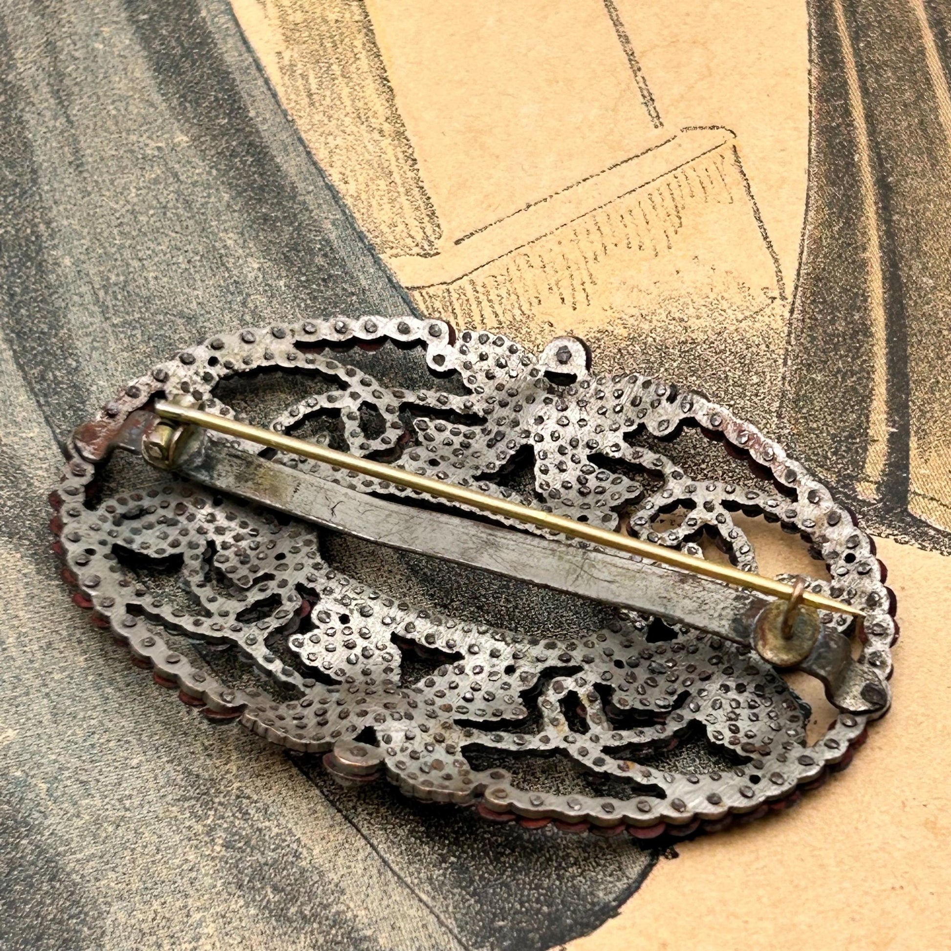 back of Antique butterfly brooch cut steel pinned construction on printed magazine - Splendid Vintage World