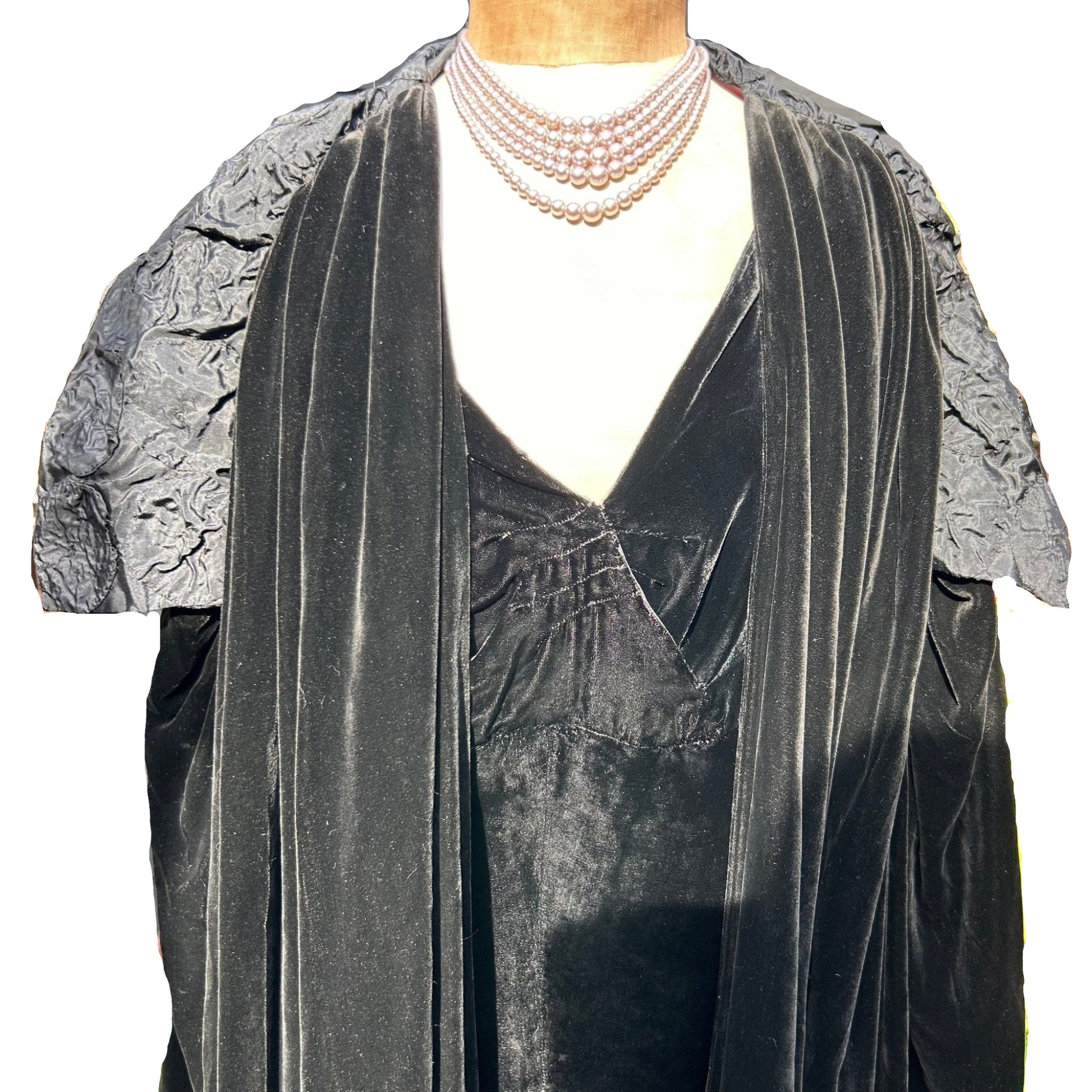 Art Deco black velvet cocoon cape with silk feature collar on a mannequin on white background - Splendid Vintage World