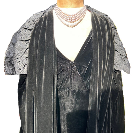 Art Deco black velvet cocoon cape with silk feature collar on a mannequin on white background - Splendid Vintage World