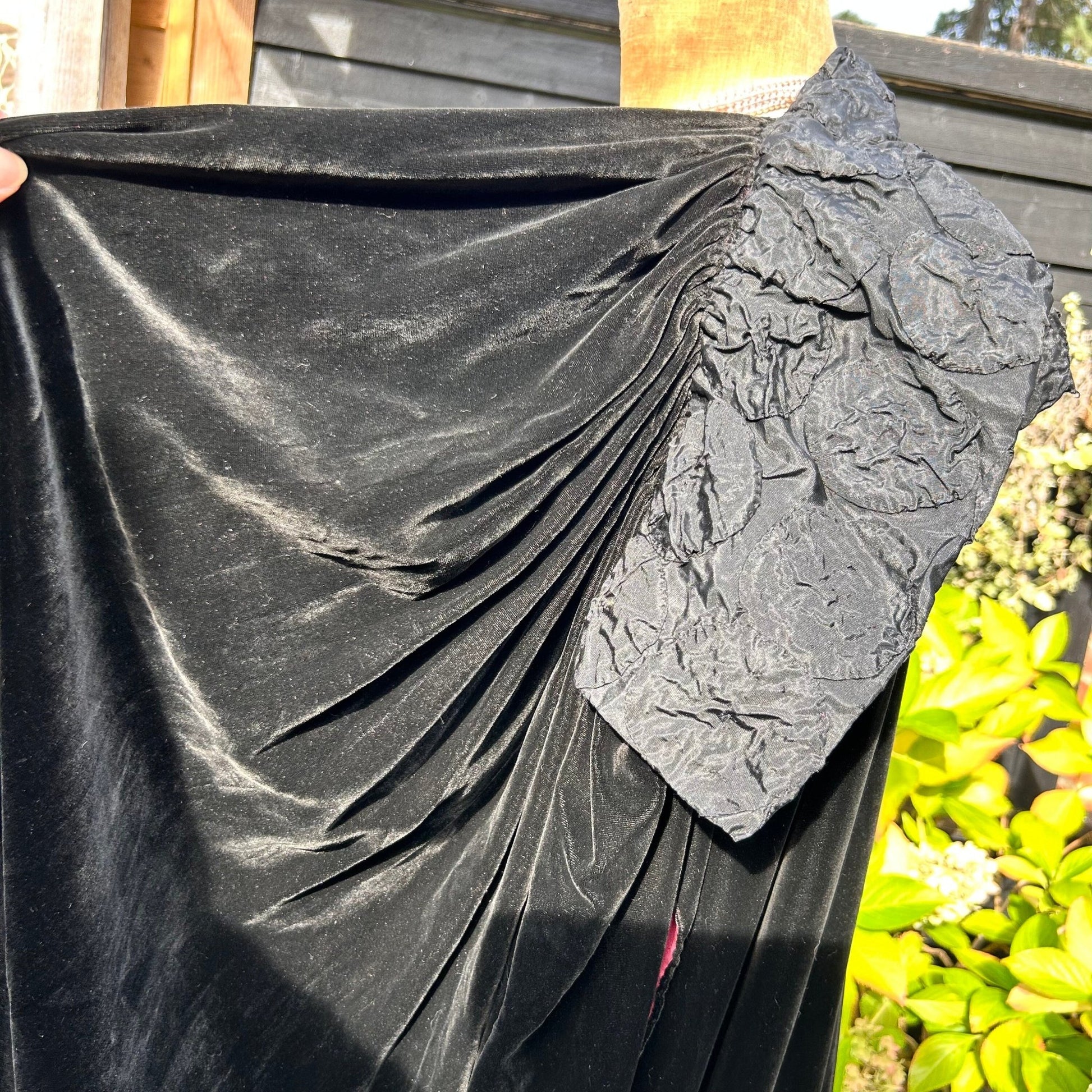 Art Deco black velvet cocoon cape with feature collar gathered detail in garden setting - Splendid Vintage World
