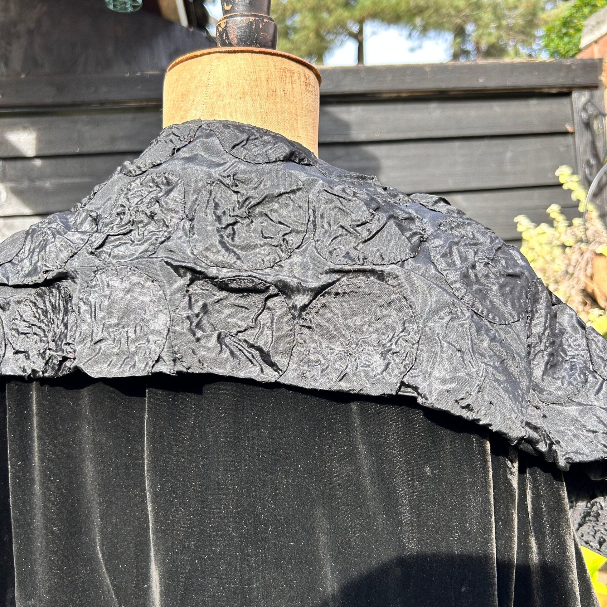 Art Deco black velvet cape silk feature collar on mannequin against black fence - Splendid Vintage World