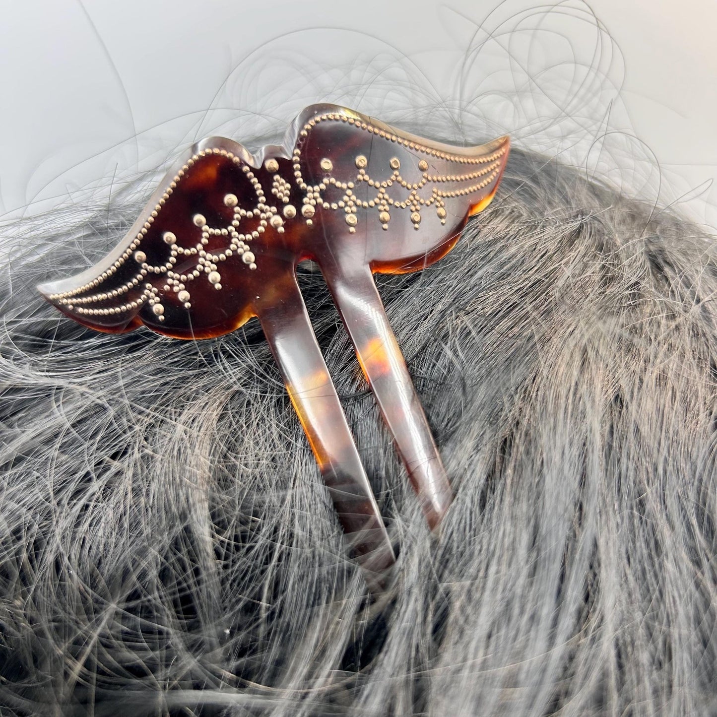 Antique Edwardian faux tortoiseshell hair pin decoration in black hair with grey background - Splendid Vintage World