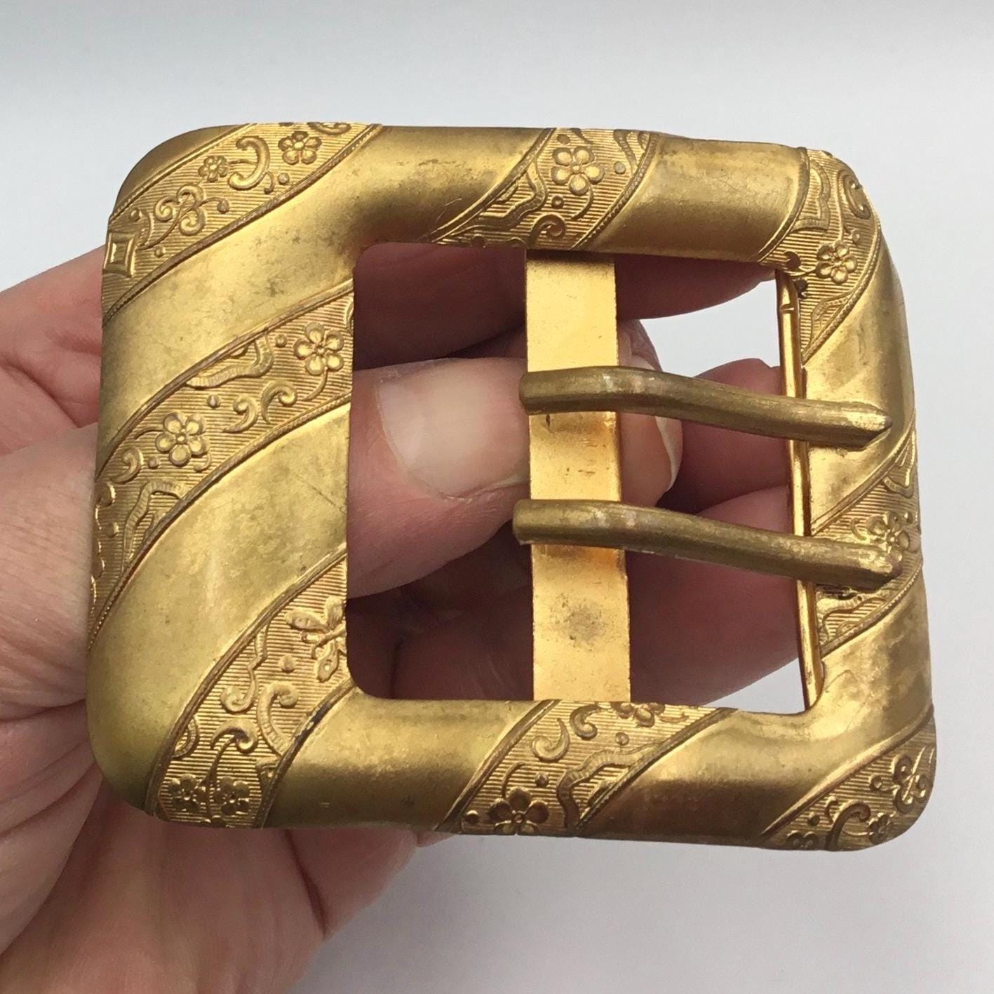 Antique Edwardian gilt metal buckle With floral & butterfly detail in between plain diagonal bands - Splendid Vintage World