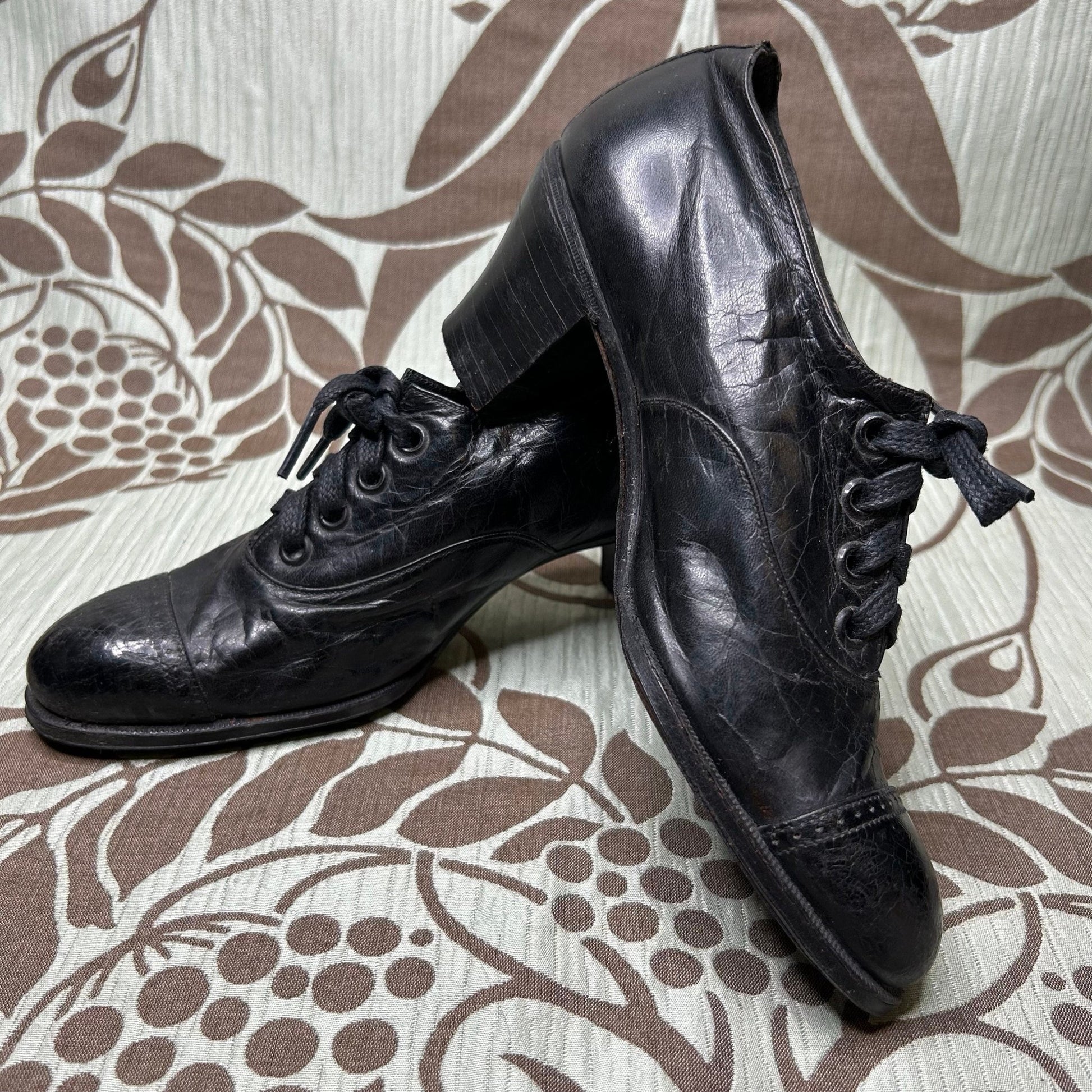 Antique Edwardian Ladies black leather lace up Oxford heeled shoes on patterned background - Splendid Vintage World
