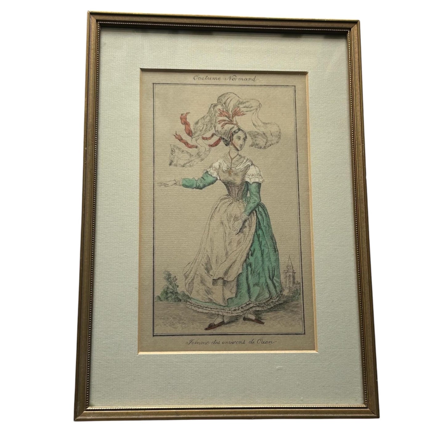 Antique French Print of a lady in Caen costume with pale card mount & gold Frame on a white background Splendid Vintage World