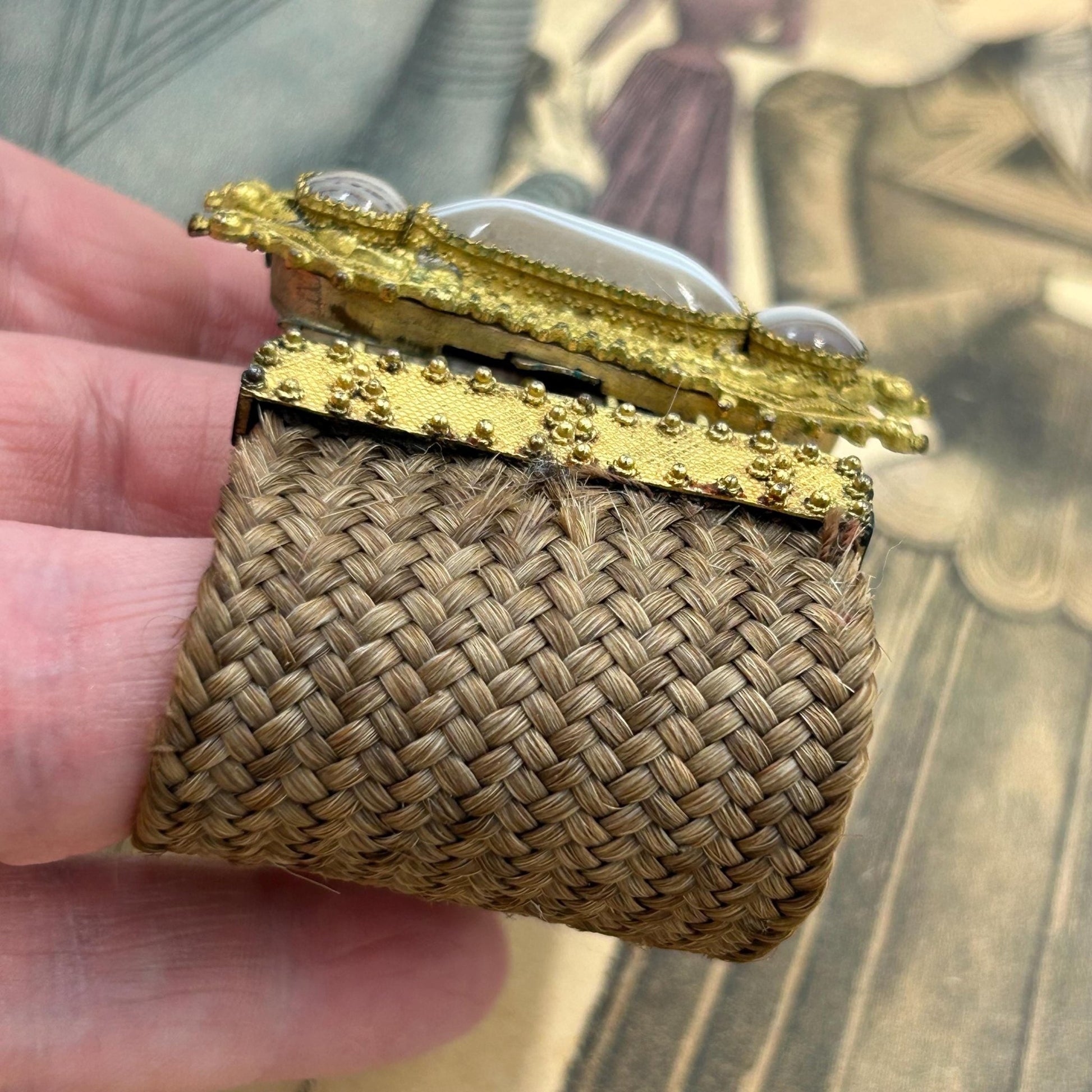 Antique Georgian Woven Hair Cuff Bracelet Gilt Metal & Agates held by hand on printed magazine - Splendid Vintage World