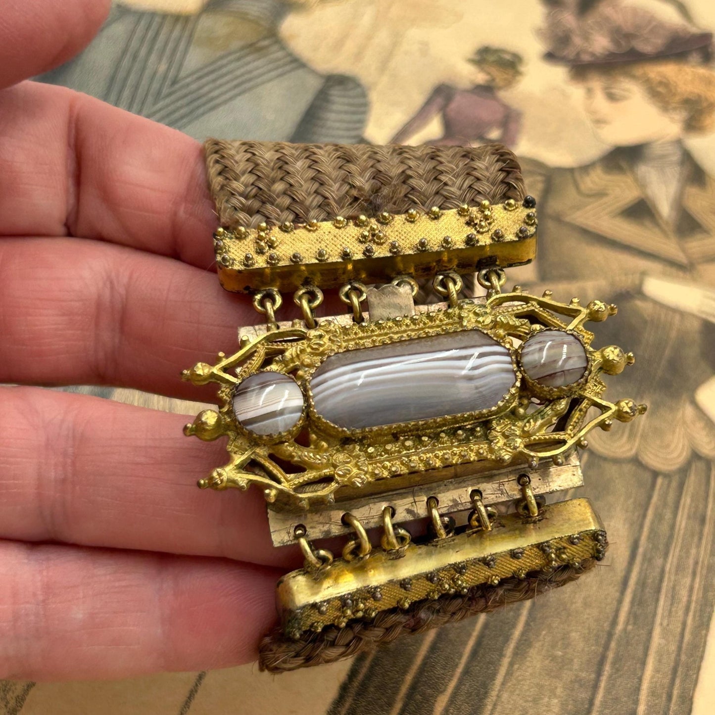 Antique Georgian Woven Hair Cuff Bracelet Gilt Metal & Agates held on hand on printed magazine - Splendid Vintage World