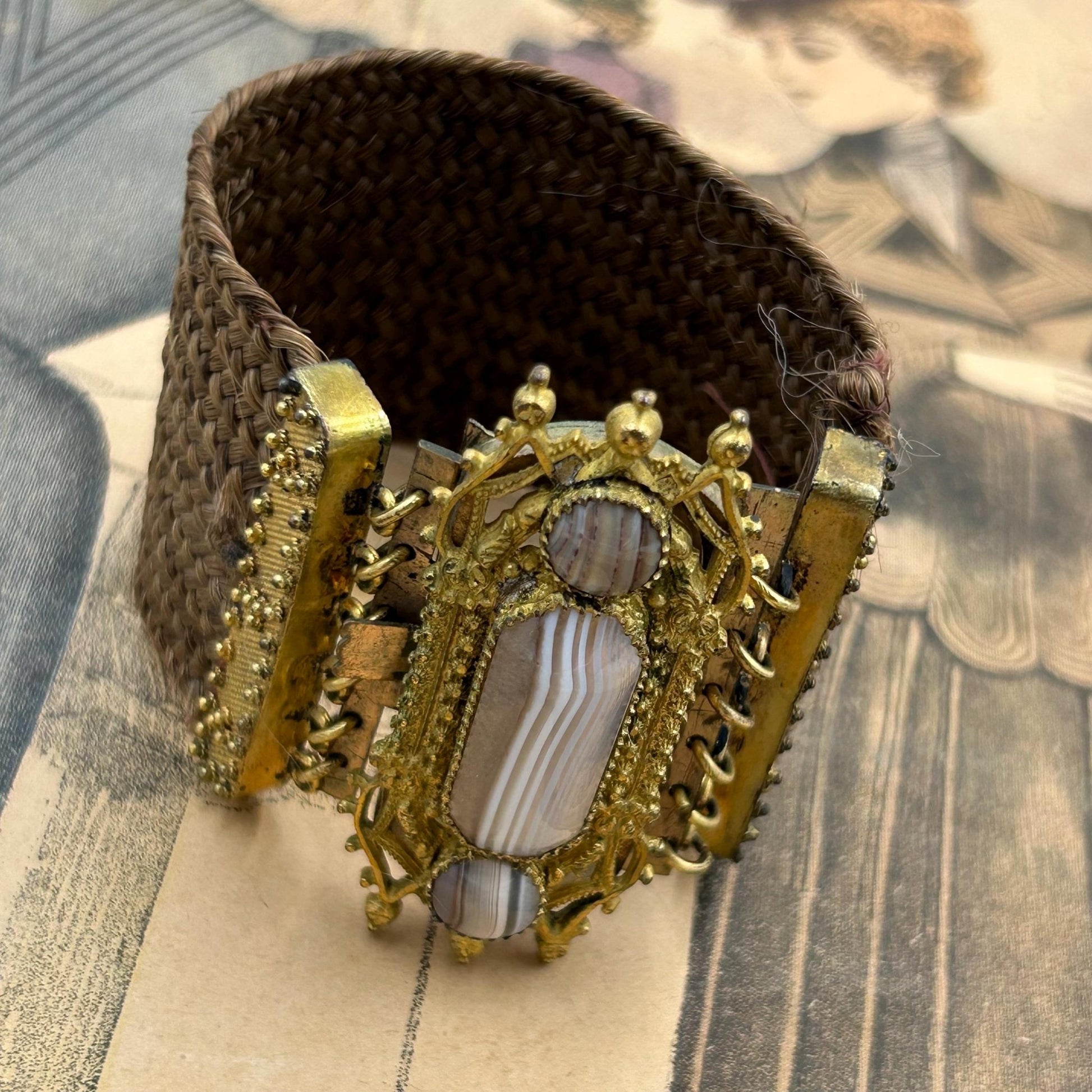 Antique Georgian Woven Hair Cuff Bracelet Gilt Metal & Agates on printed magazine - Splendid Vintage World