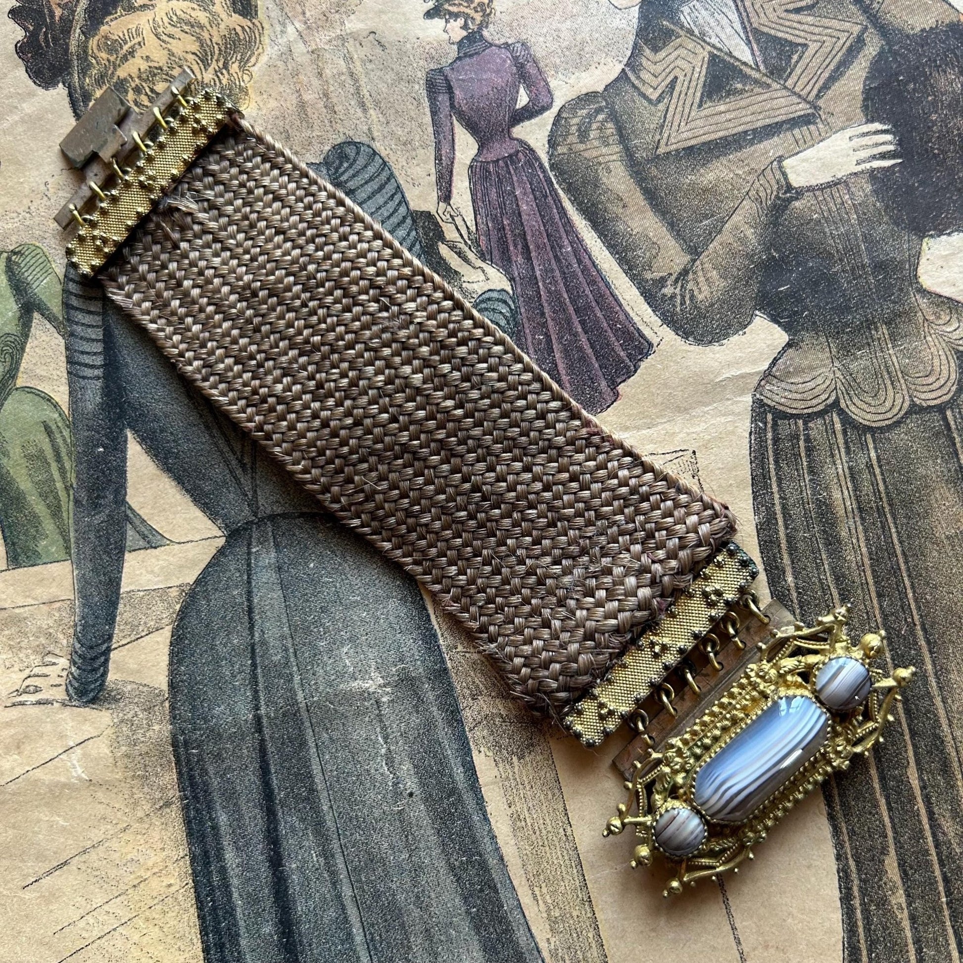 Antique Georgian Woven Hair Cuff Bracelet Gilt Metal & Agate laid flat on printed victorian magazine - Splendid Vintage World
