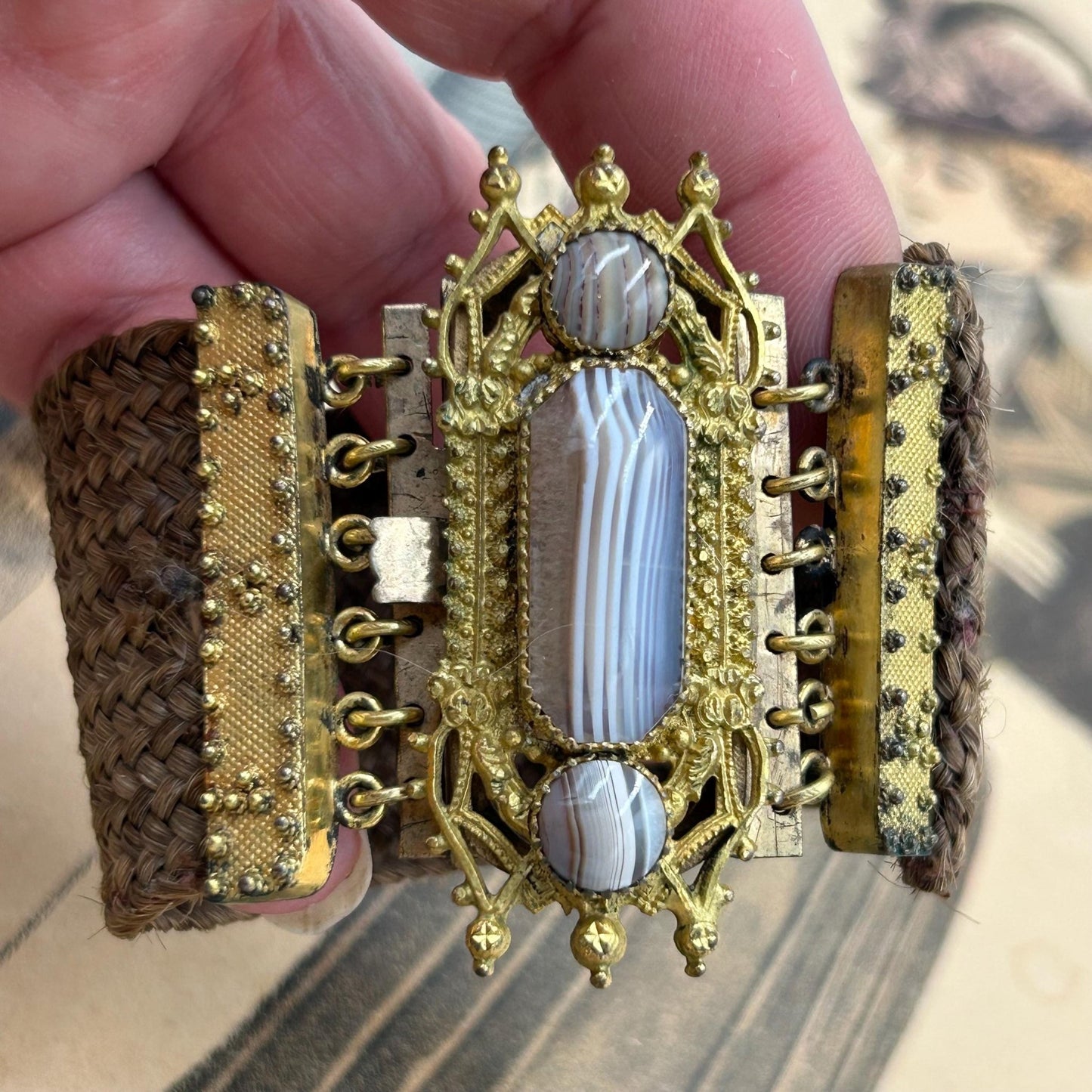 Antique Georgian Woven Hair Cuff Bracelet Gilt Metal & Agates held by hand on printed background - Splendid Vintage World