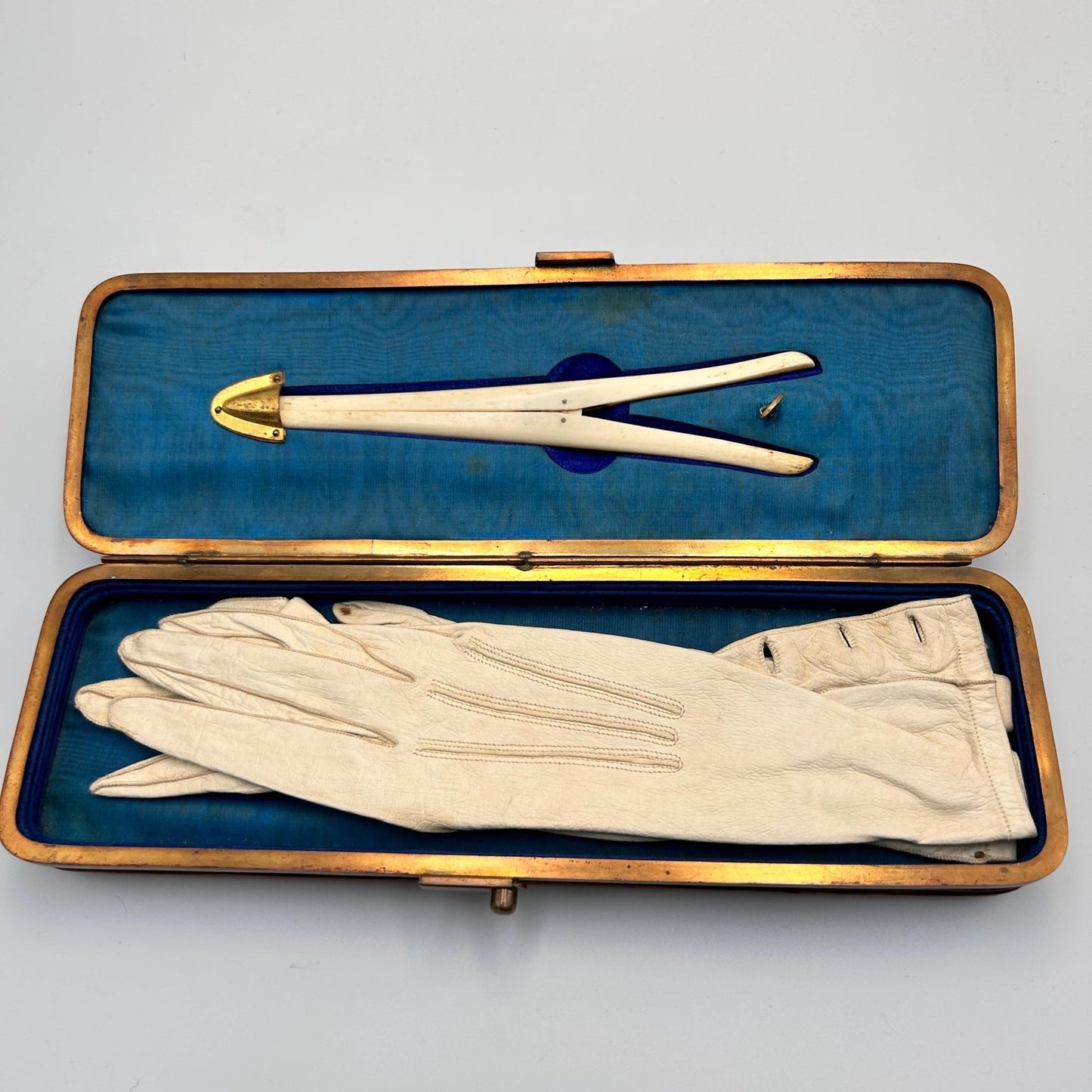 Antique leather expanding glove box lined in blue silk with a pair of gloves & glove stretchers