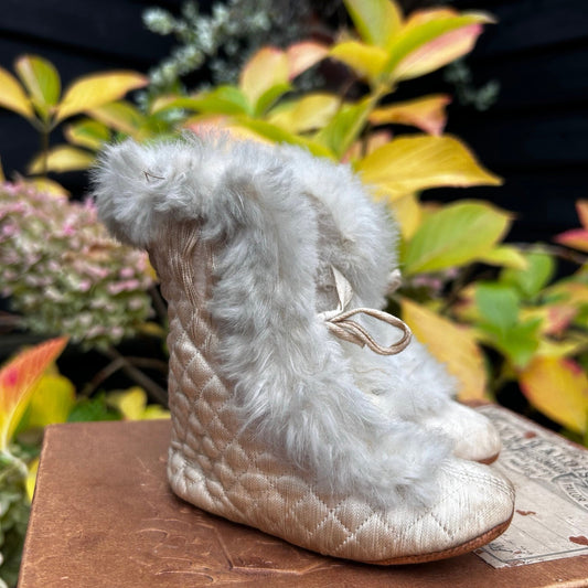quilted fur trimmed baby boots distressed condition on wooden surface & planted background - Splendid Vintage World