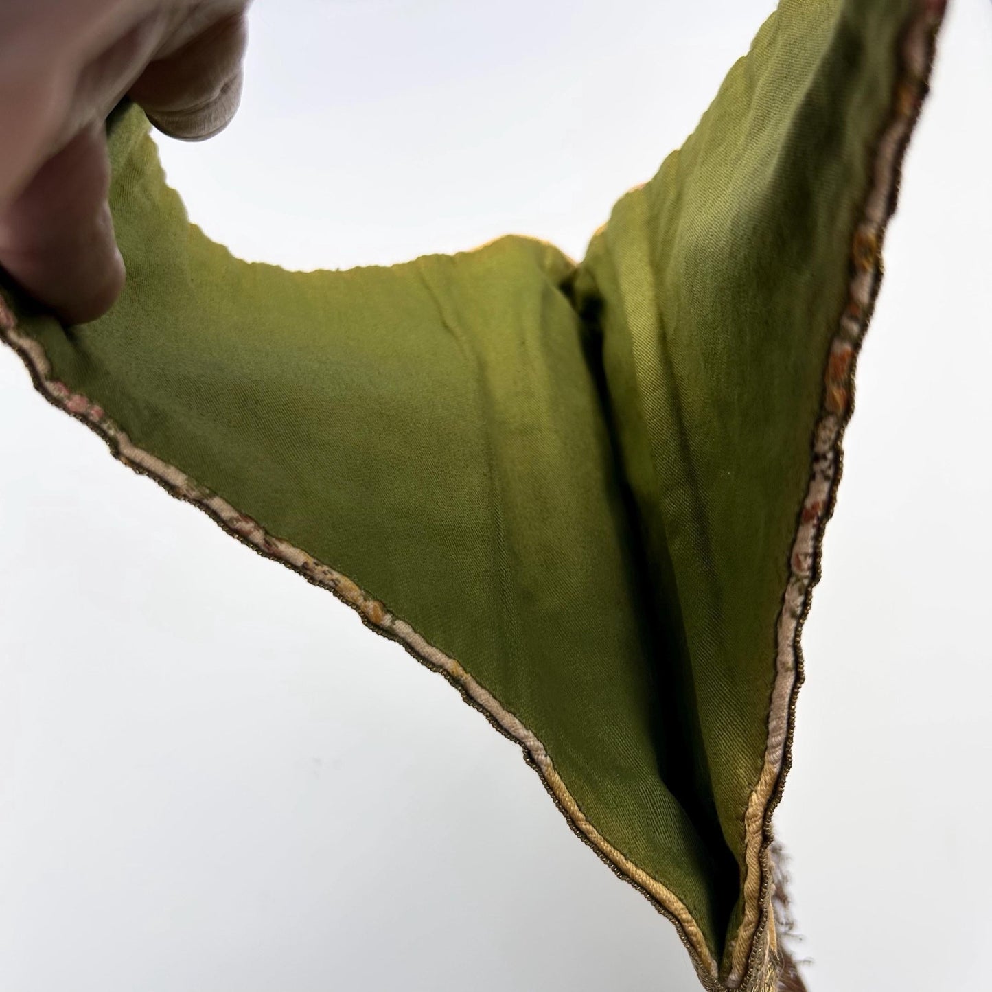 Green lining within the strap of an Antique Silk Brocade Bag with white background - Splendid Vintage World