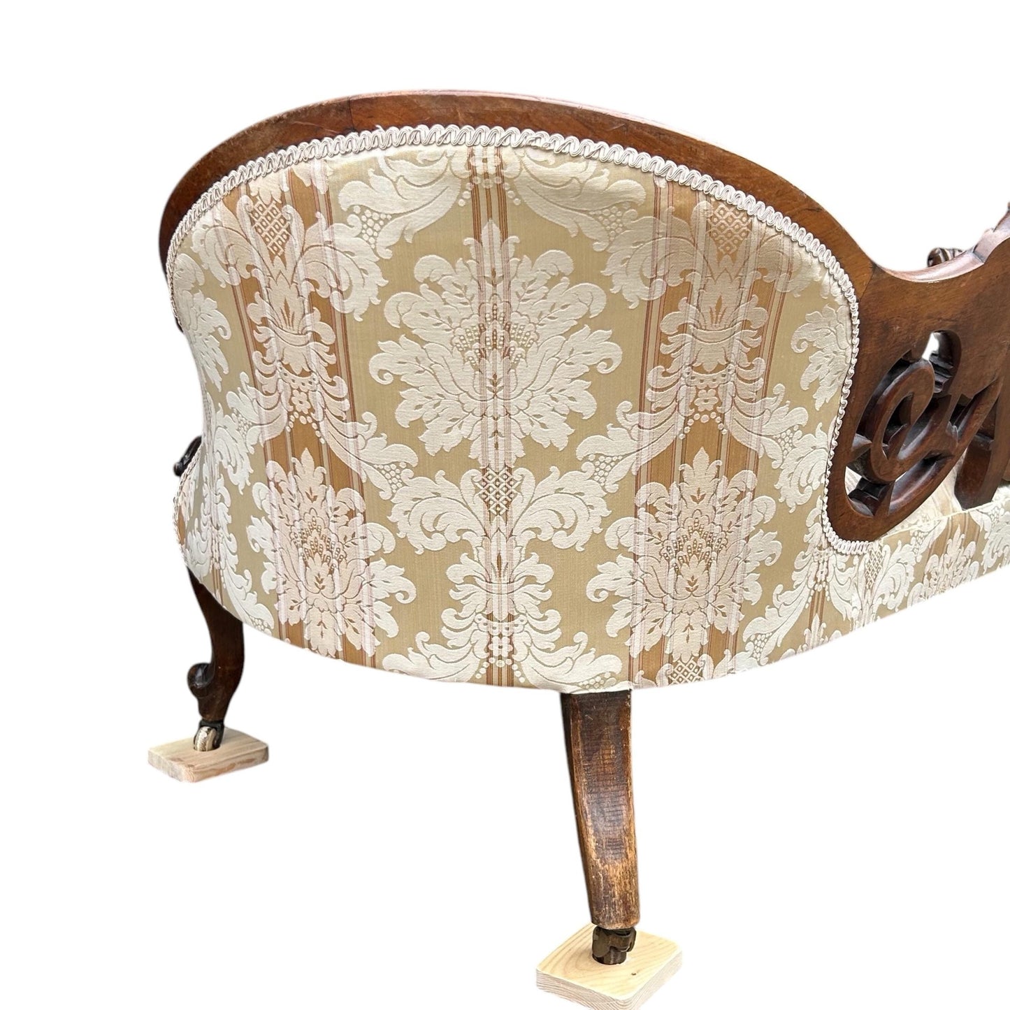 Back end close up of Victorian carved walnut cameo back sofa chaise upholstered in beautiful traditional damask