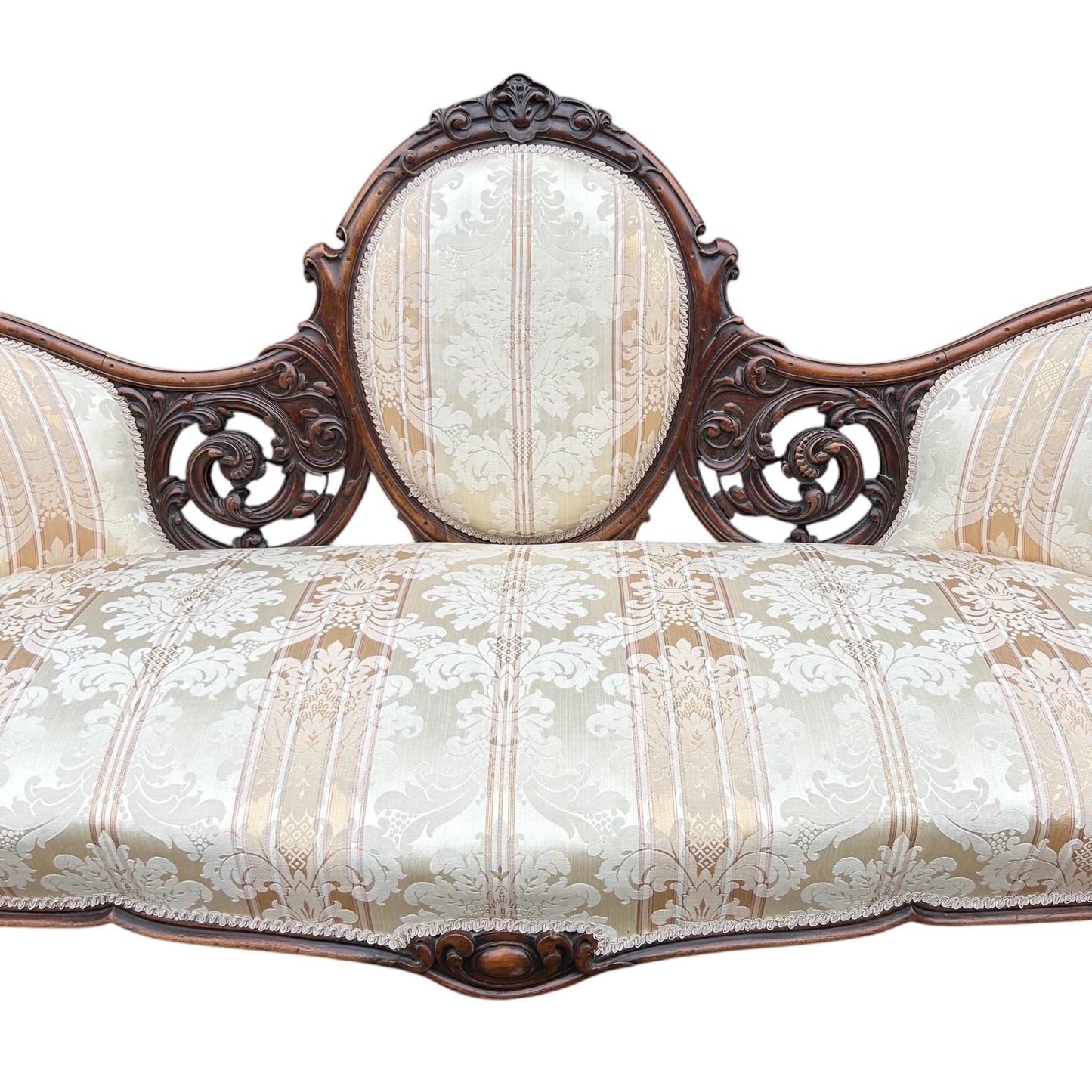 Centre close up of Victorian carved walnut cameo back sofa chaise upholstered in beautiful traditional damask