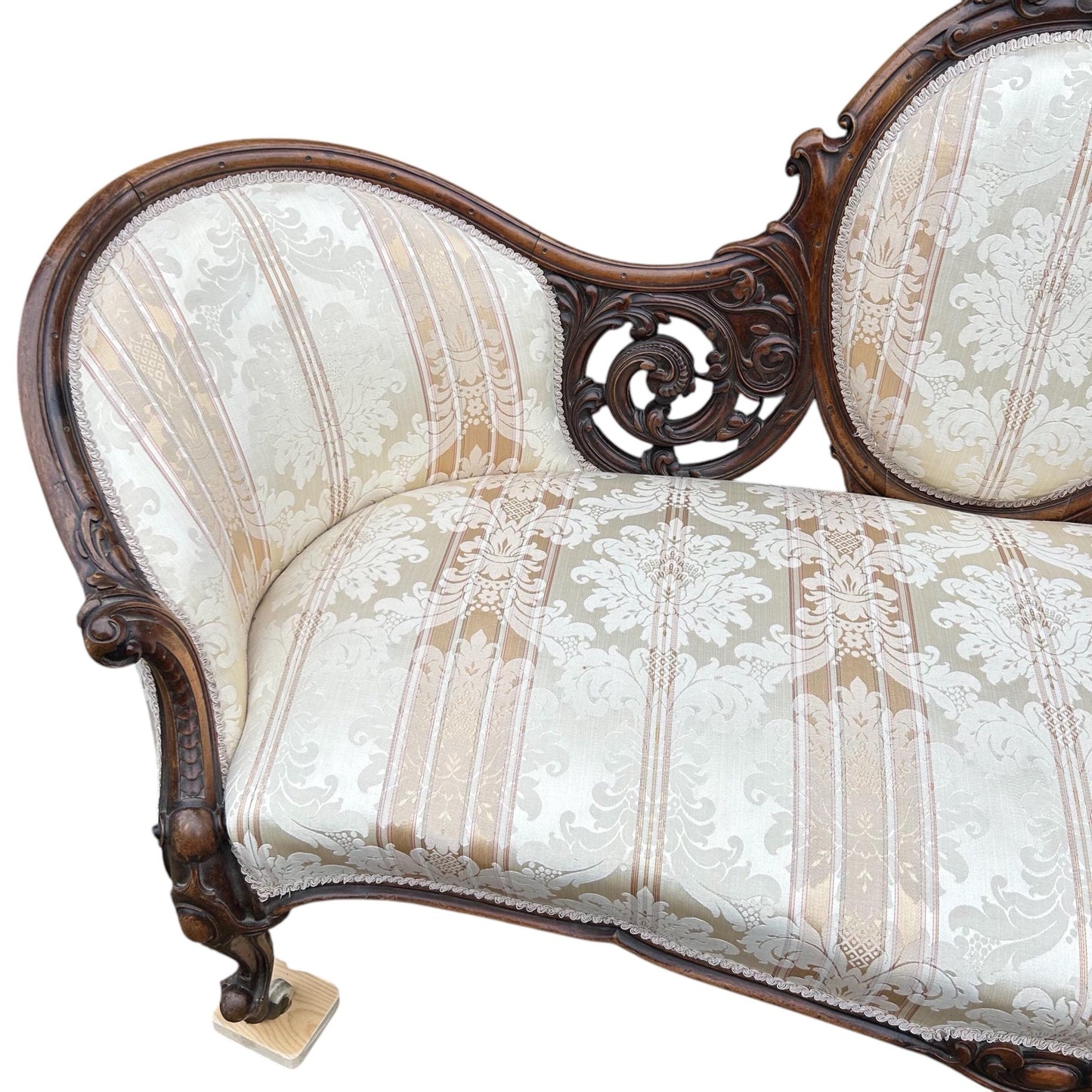 End close up of Victorian carved walnut cameo back sofa chaise upholstered in beautiful traditional damask
