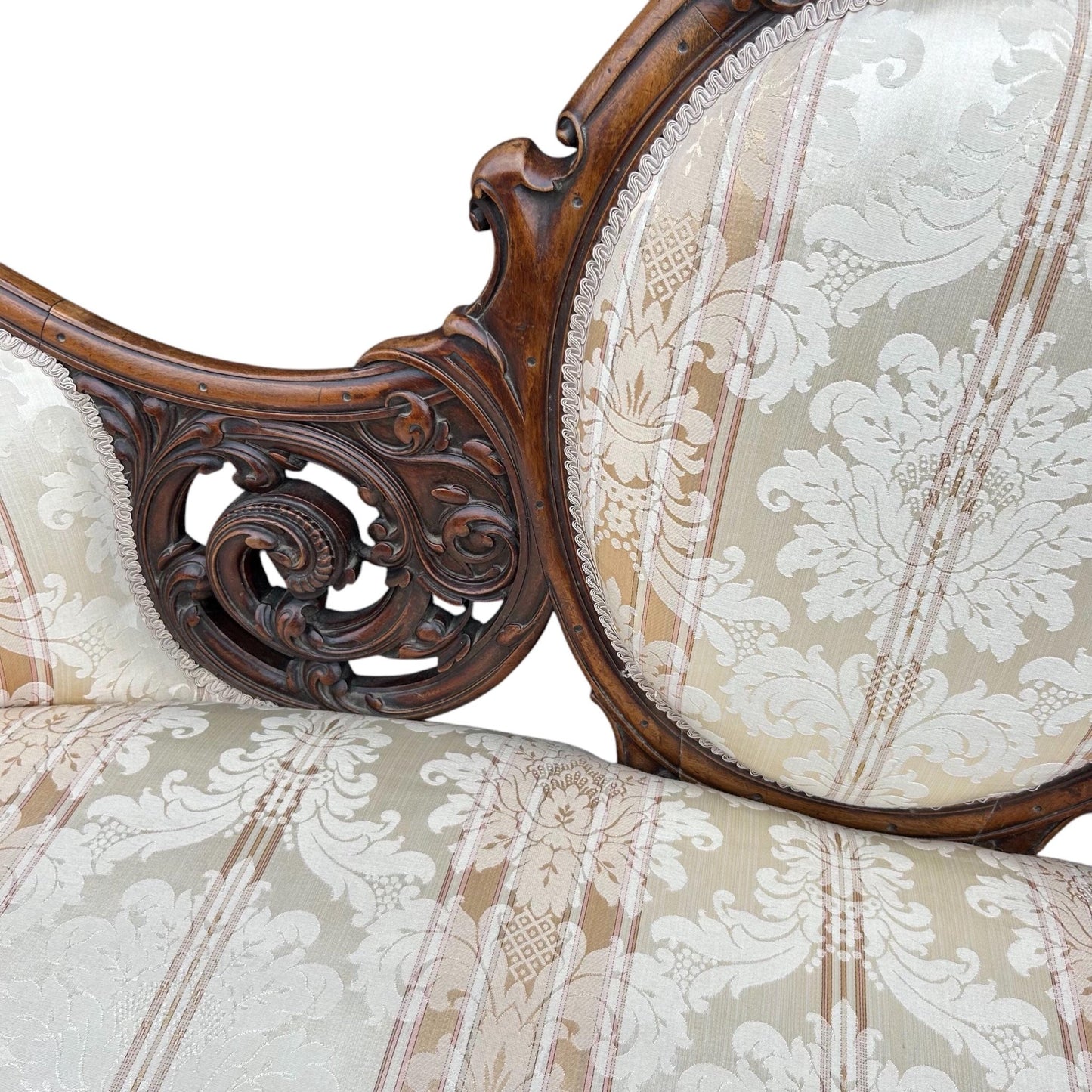 Carving close up of Victorian carved walnut cameo back sofa chaise upholstered in beautiful traditional damask