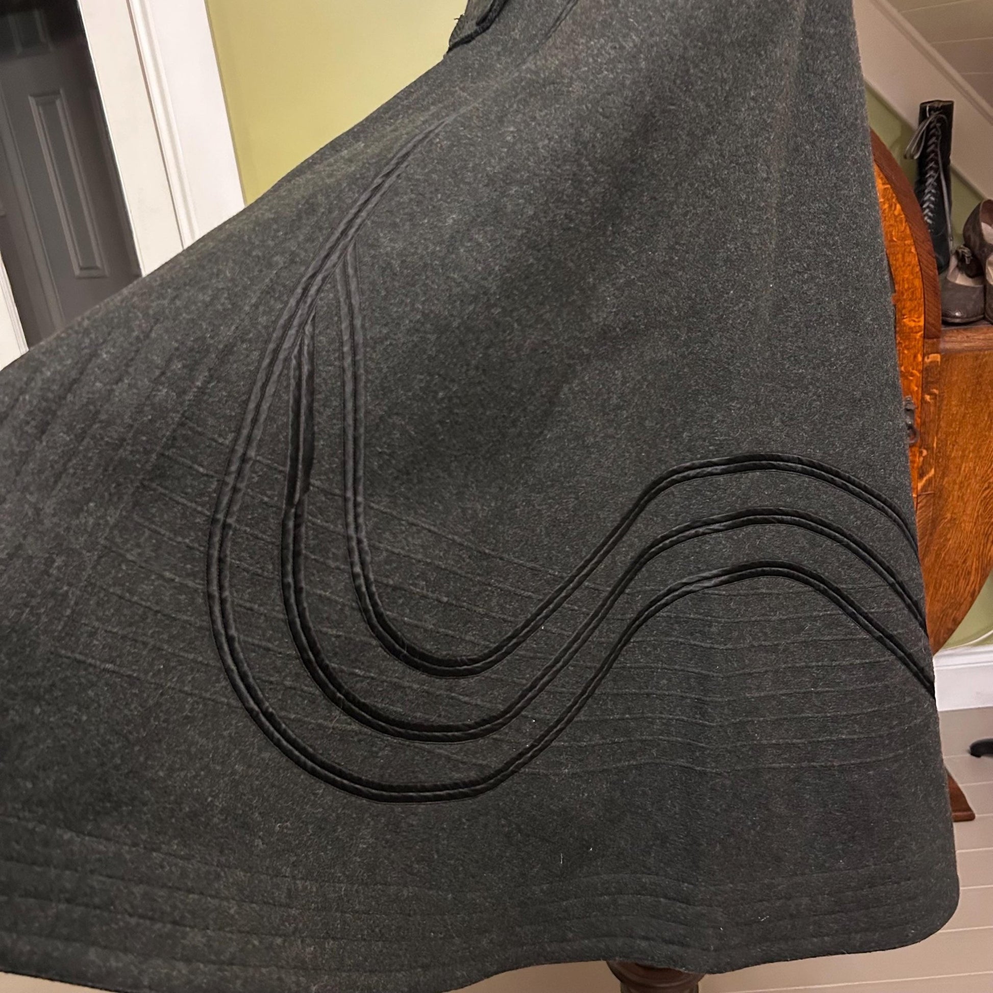 Antique Victorian dark grey wool cape with black wavy lines in room setting - Splendid Vintage World