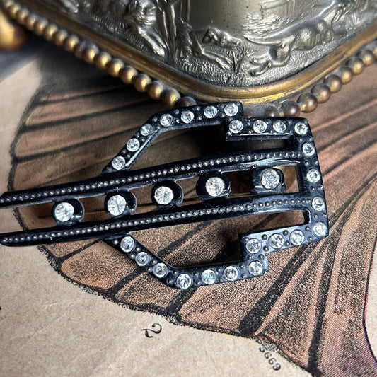 Art Deco black Hat Pin with diamanté and fine pin detail on illustrated magazine background - Splendid Vintage World