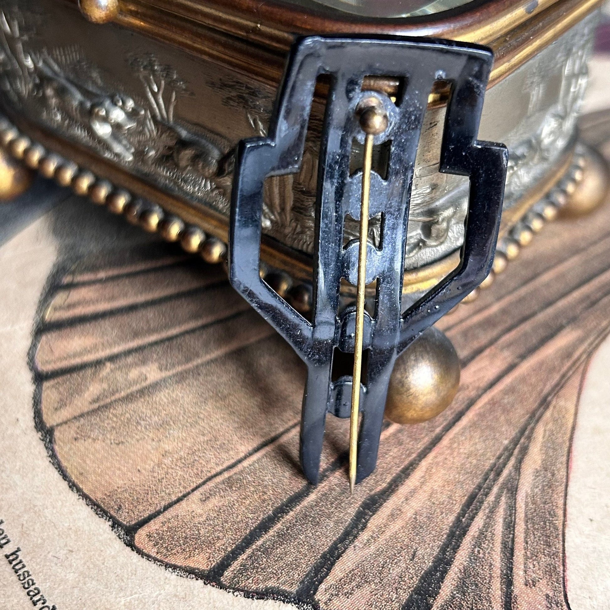 Art Deco Diamante Hat Pin standing on illustrated magazine background - Splendid Vintage World