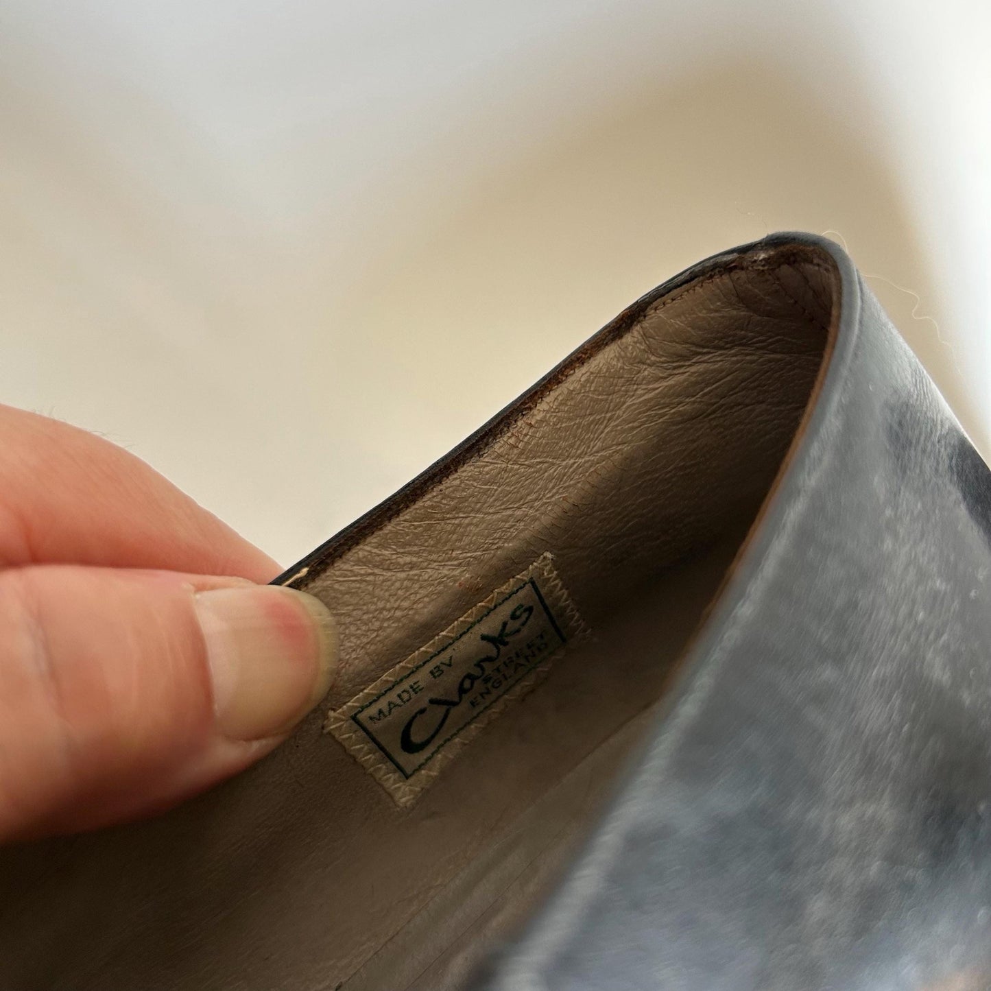 1920s Black Leather Mary Jane Shoe held by hand showing inside label - Splendid Vintage World