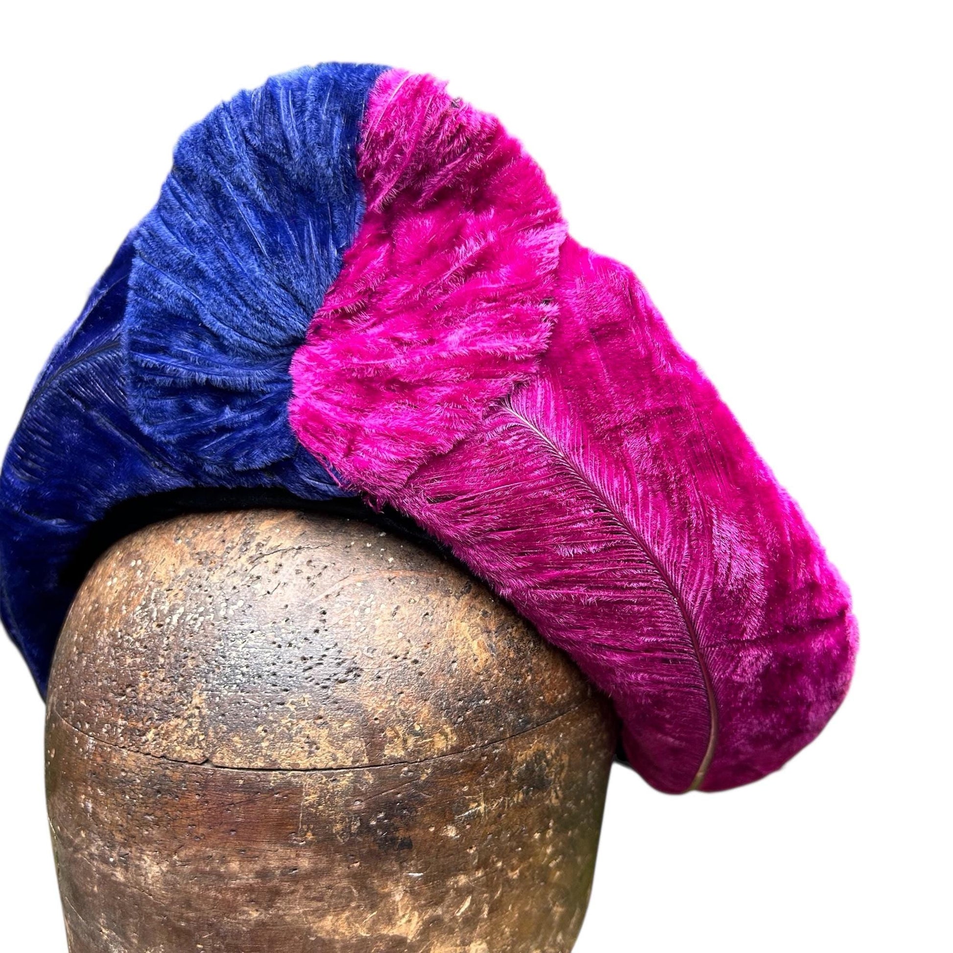 vibrant blue and pink ostrich feather hat on brown wooden hat block on white background - Splendid Vintage World