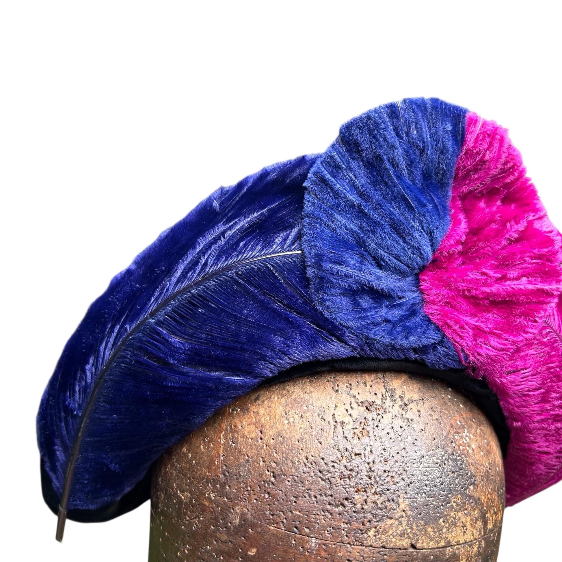 vibrant blue and pink ostrich feather hat on brown wooden hat block on white background - Splendid Vintage World